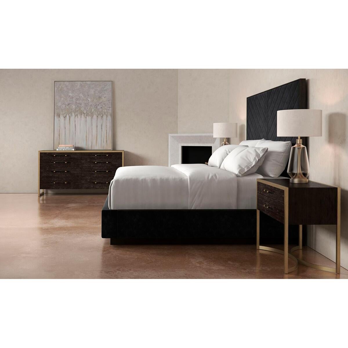 Upholstered King Bed with a black stain Ash finish frame. It has a tall upholstered headboard with a modern channel tufting design of converging angles that meet in the center to create a mesmerizing chevron. This bed’s fully finished sides appear