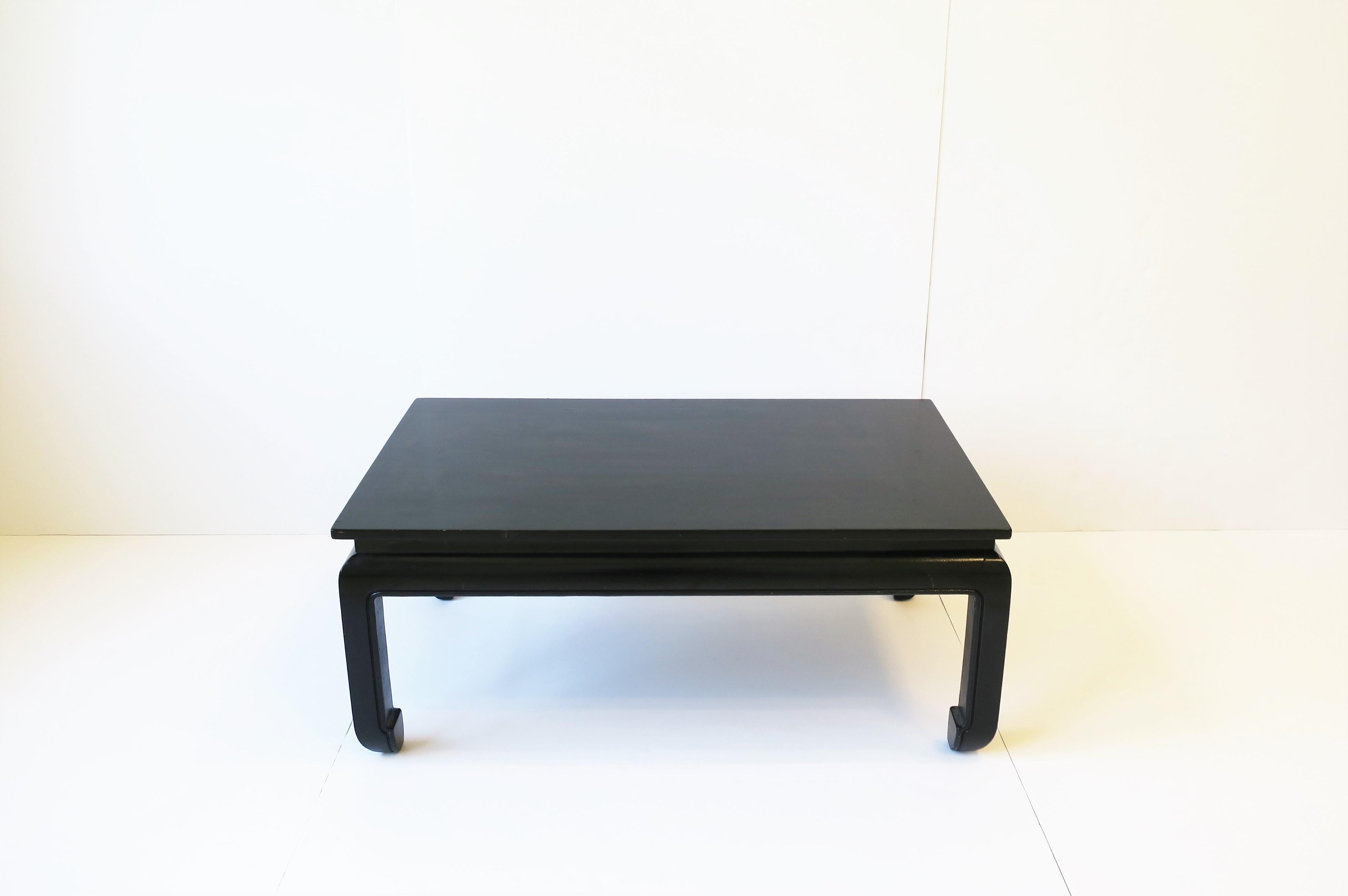 A chinoiserie style black rectangular coffee/cocktail table, circa mid to late-20th century. Black finish, professionally applied, has a nice sheen/shine. Table is convenient size and on the smaller side; Dimensions: 16