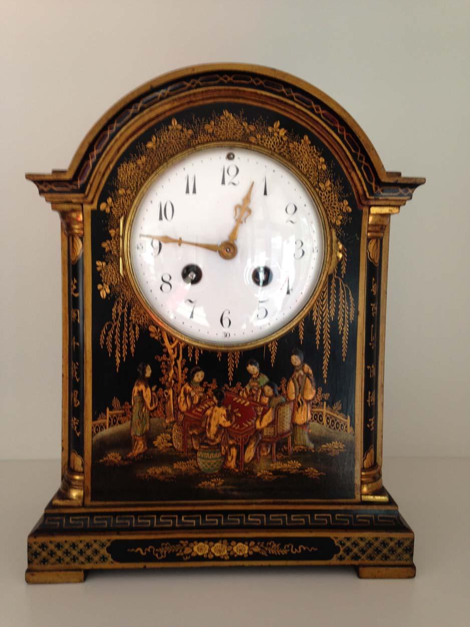 A fine English black chinoiserie Georgian style break arch mantel clock with profusely decorated case with scenes of pagodas, garden scenes and a rare front panel of four ladies sat around a table playing a game - possibly mahjong whilst others