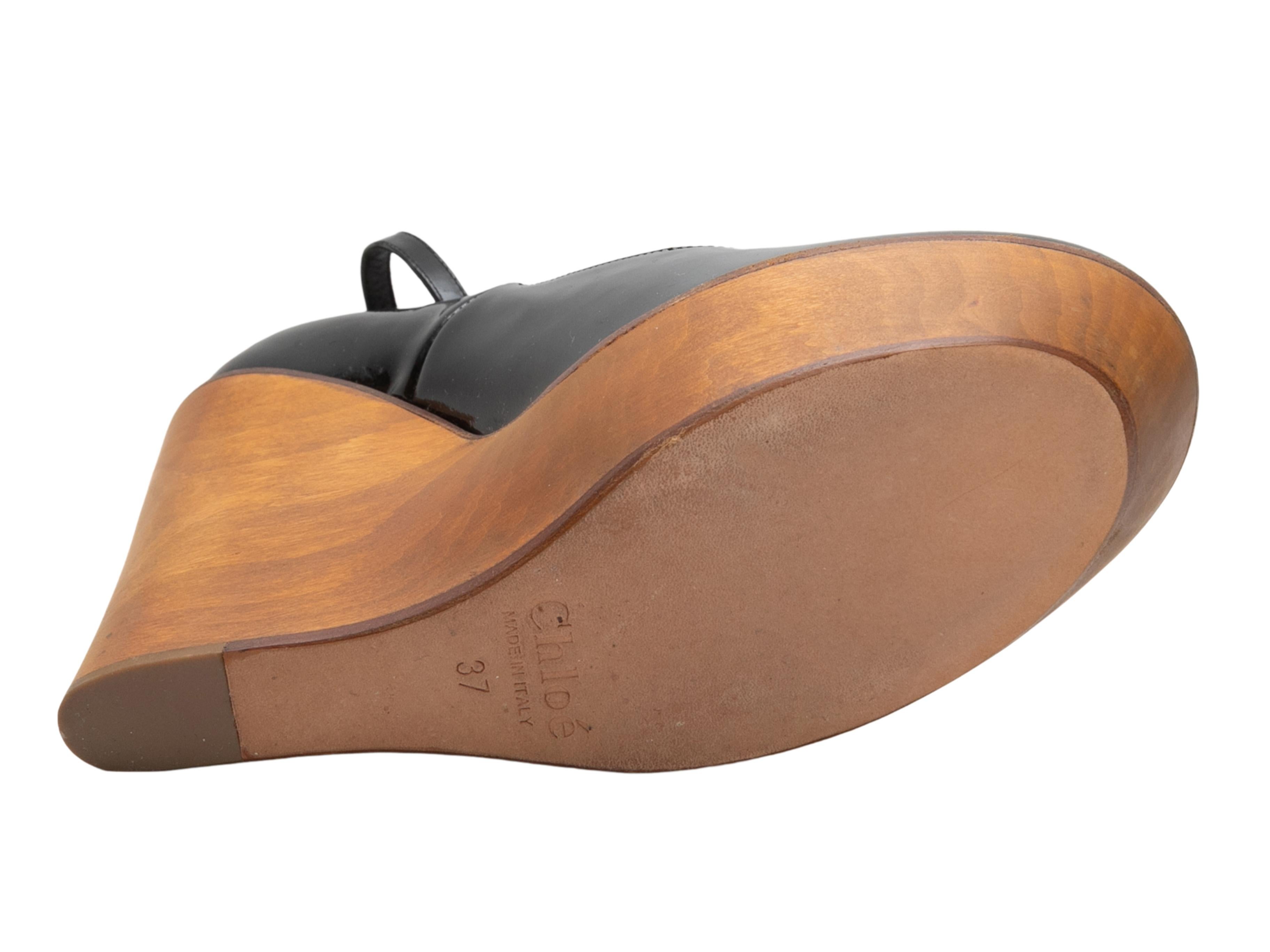  Black patent leather wooden wedge heels by Chloe. Buckle closures at ankle straps. 1