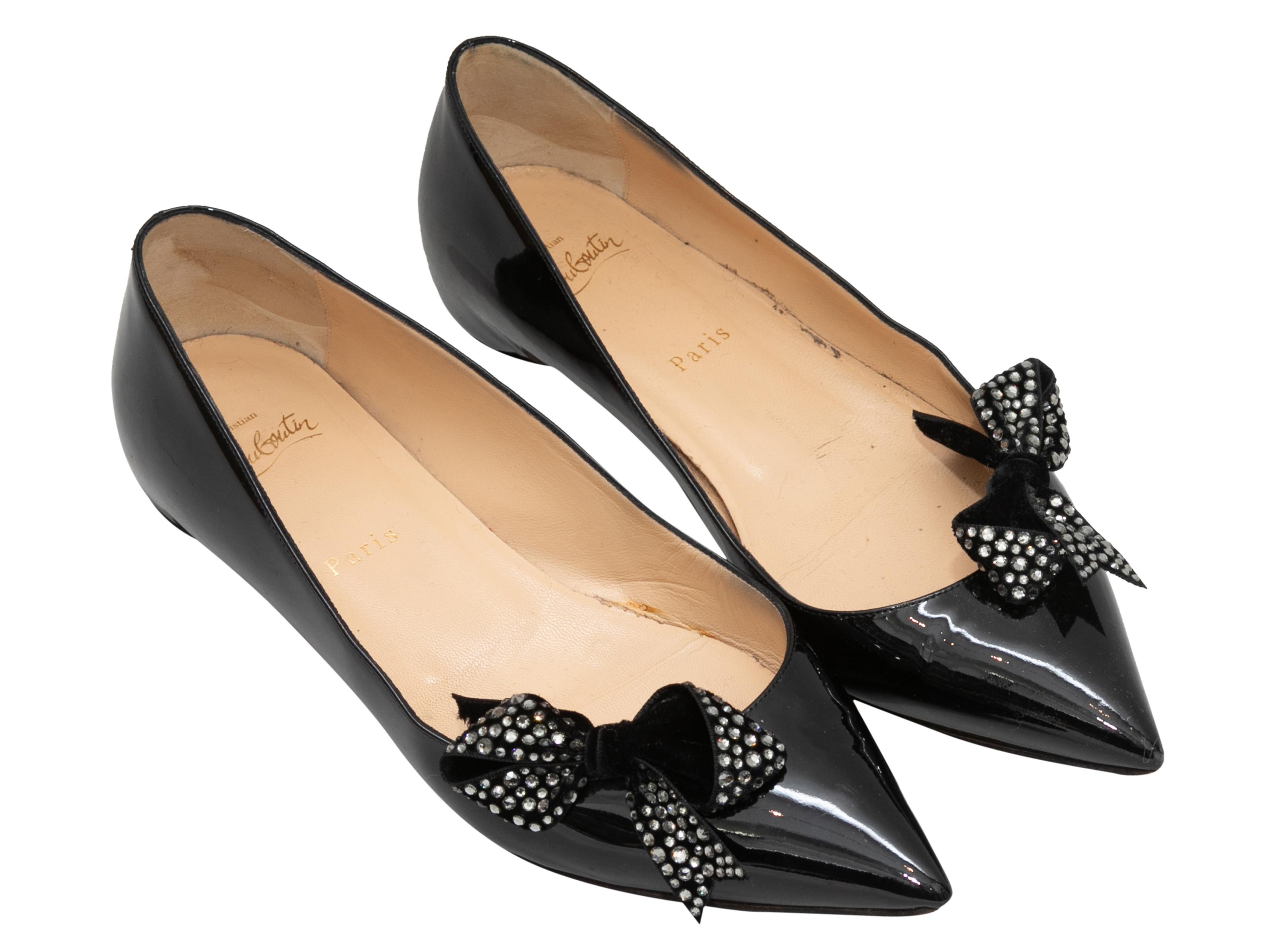 Black patent leather pointed-toe ballet flats by Christian Louboutin. Crystal-embellished bow accents at tops.

Designer Size: 39.5
US Recommended Size: 9.5