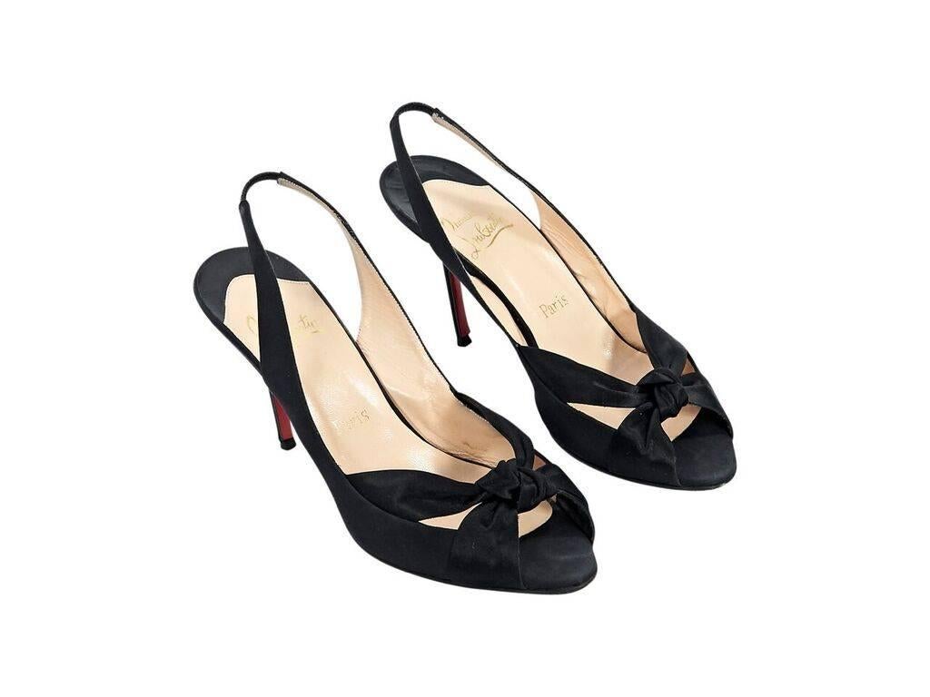 Product details:  Black satin slingback pumps by Christian Louboutin.  Slingbac strap with inset elastic panel.  Knotted vamp.  Peep toe.  Iconic red sole.  Slip-on style.  Euro size 40.  4