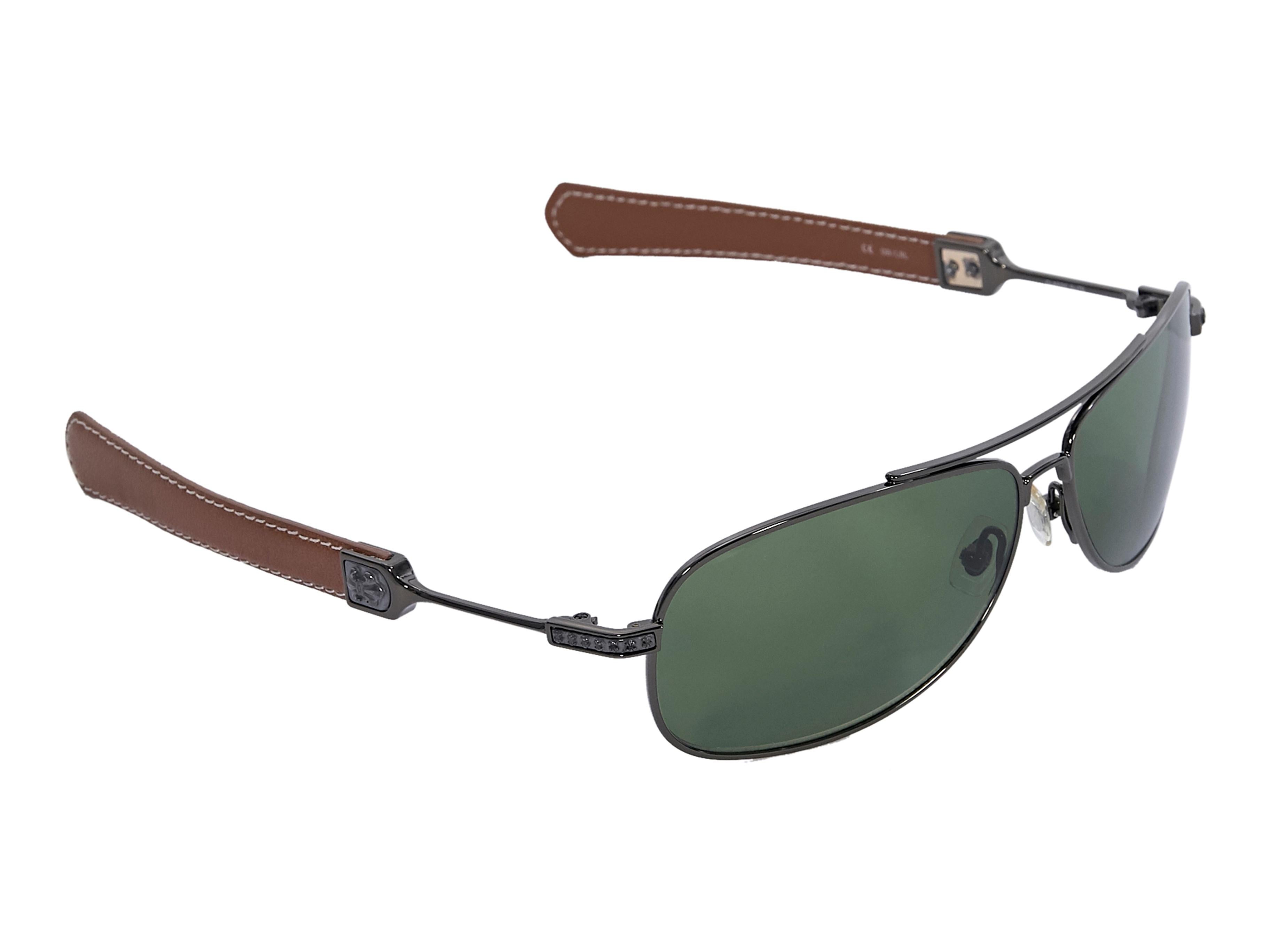 Product details:  Black metal and brown leather-trimmed aviator sunglasses by Chrome Hearts. Green gradient lenses. Case and cleaning cloth included. Style with a cream leather shift dress. 5.5