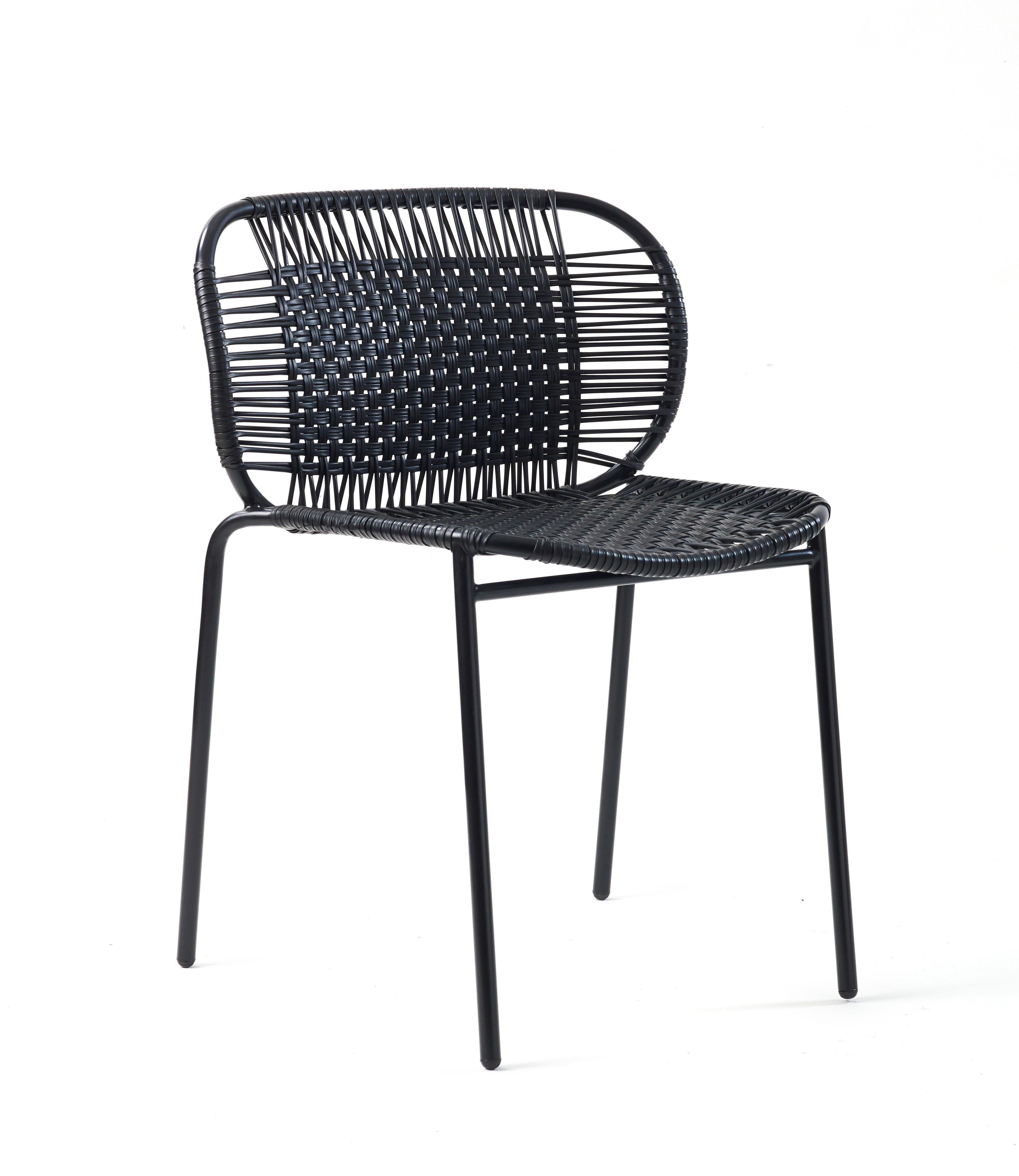 Black Cielo stacking chair by Sebastian Herkner
Materials: PVC strings, powder-coated steel frame. 
Technique: Made from recycled plastic and weaved by local craftspeople in Cartagena, Colombia. 
Dimensions: W 56 x D 51.4 x H 78 cm 
Also