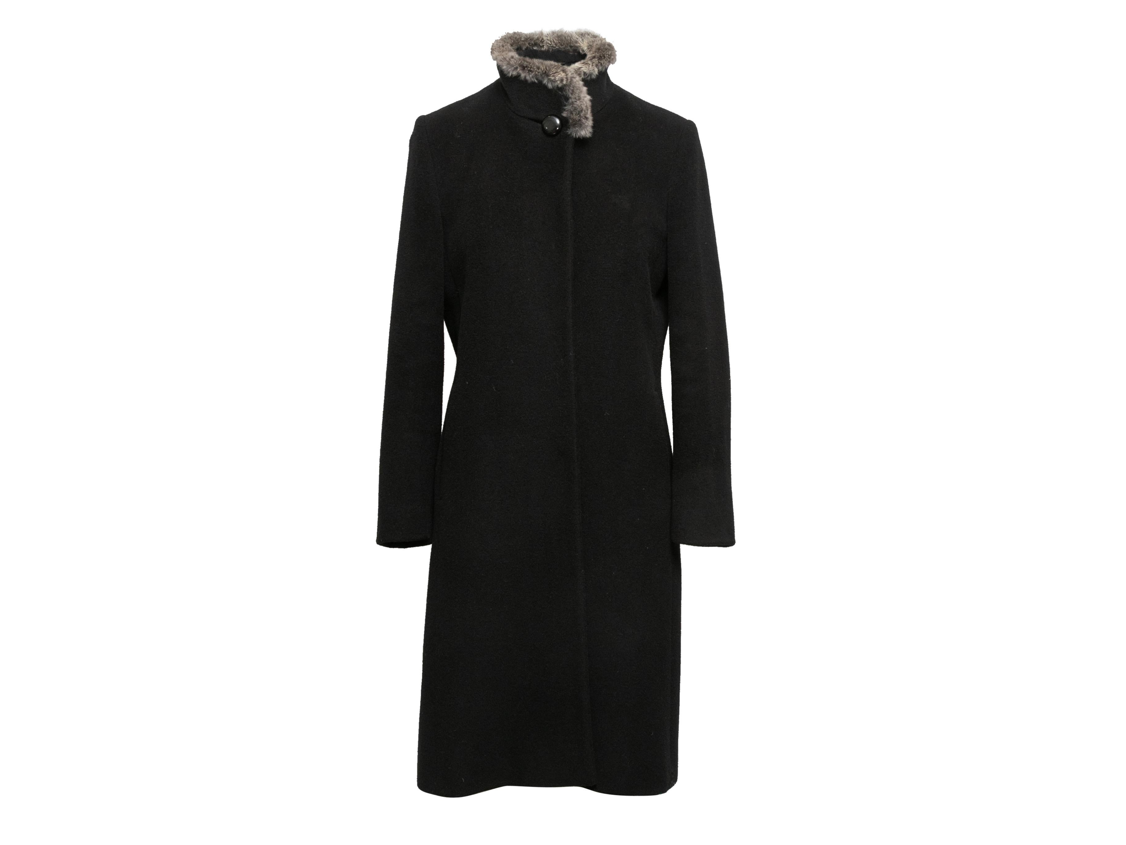 Black wool and cashmere-blend long coat by Cinzia Rocca. Chinchilla fur trim at stand collar. Front button closure. 38