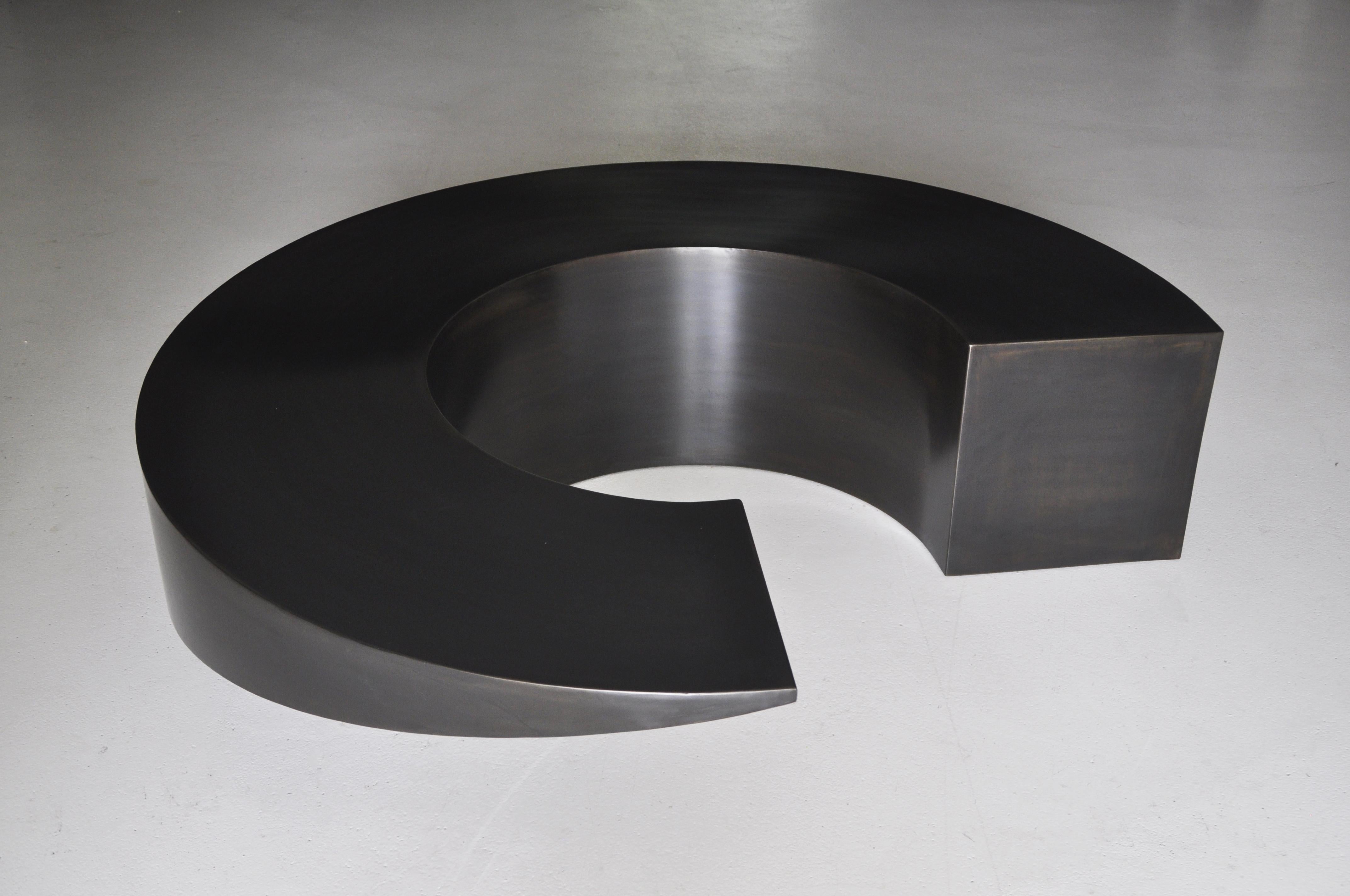 Black Circle Table by Pol Quadens 
Limited Edition Of 8+4 Pieces.
Dimensions: Ø 150 x H 40 cm.
Materials: Patinated steel.

Pol Quadens was born in Brussels. His father was active in the fields of composites the metal industry, and the world of