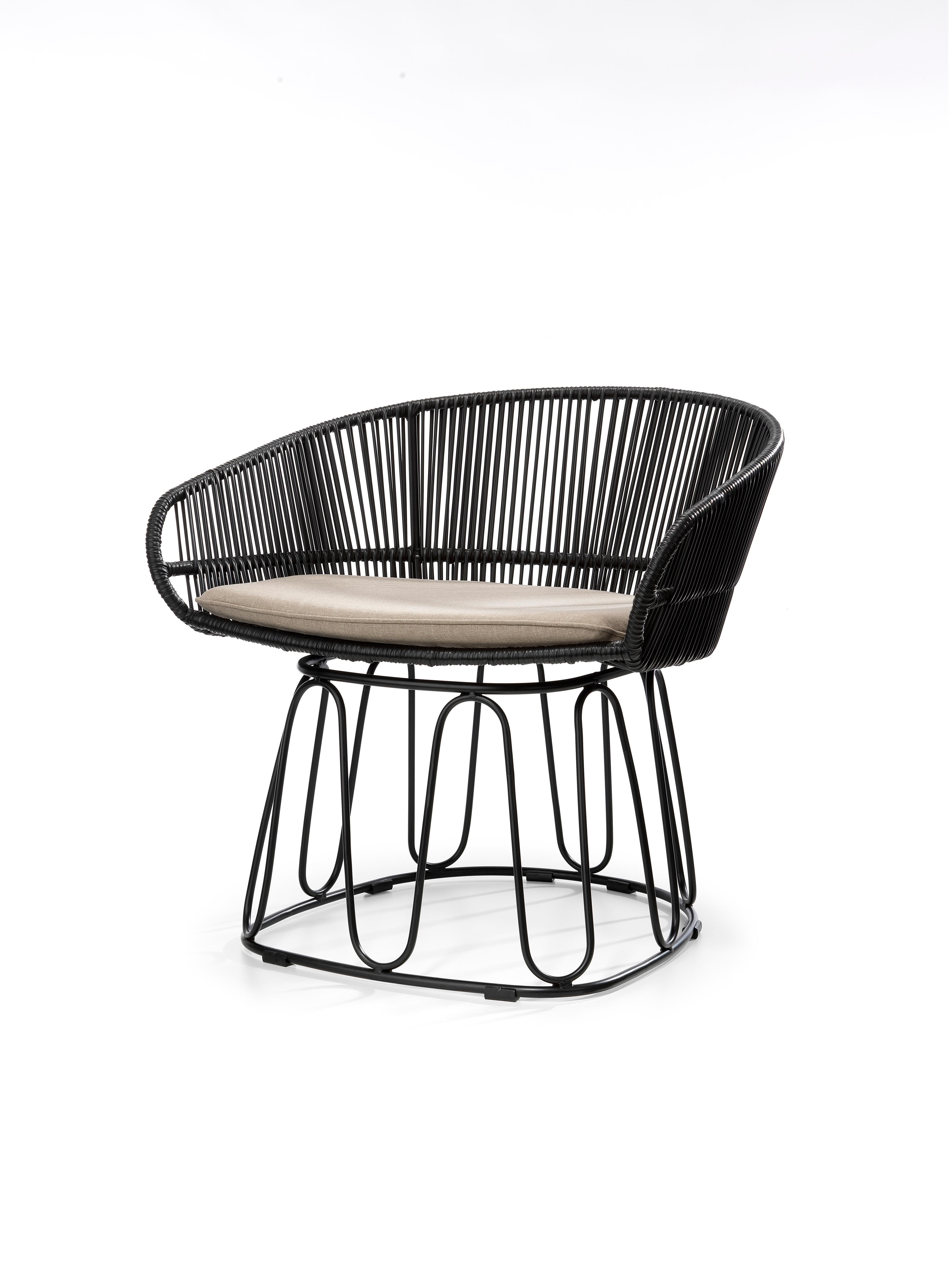 Black Circo lounge chair by Sebastian Herkner
Materials: Galvanized and powder-coated tubular steel. PVC strings.
Technique: Made from recycled plastic. Weaved by local craftspeople in Colombia. 
Dimensions: W 74 x D 66.2 x H 73 cm 
Available in