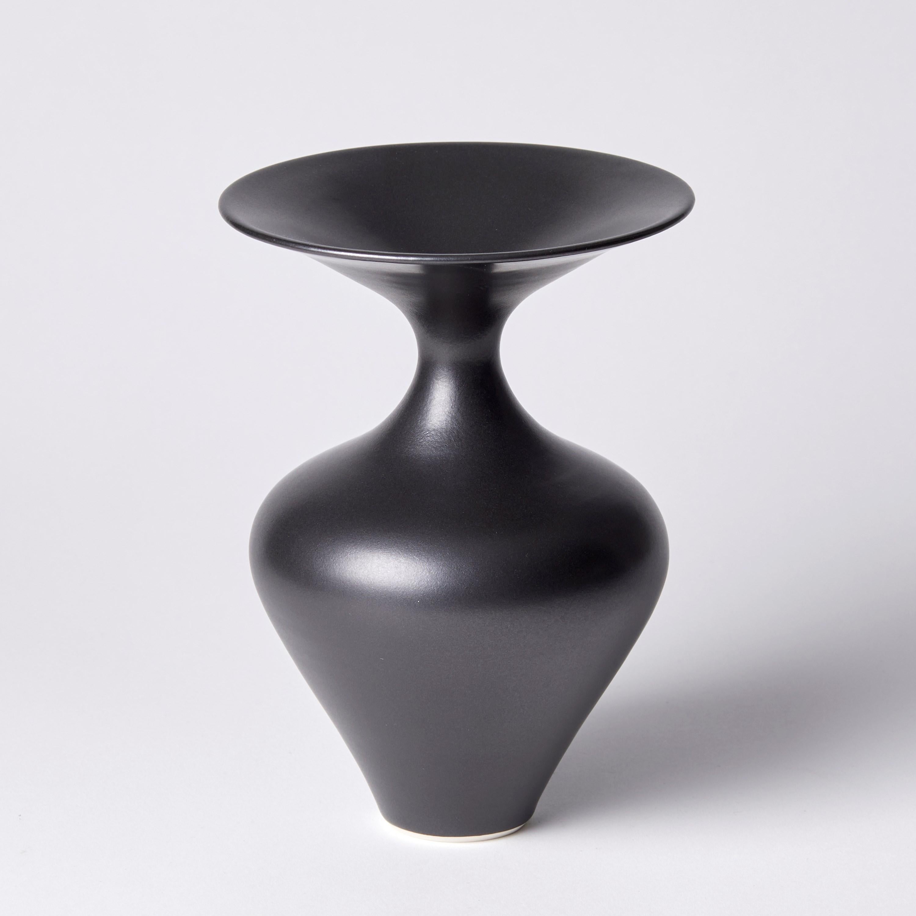 ‘Black classic vase’ is a unique porcelain sculptural vessel by the British artist, Vivienne Foley. 

Vivienne Foley is based in Gloucestershire where she produces exquisite ceramic sculpture. Although in essence they are often functional pieces