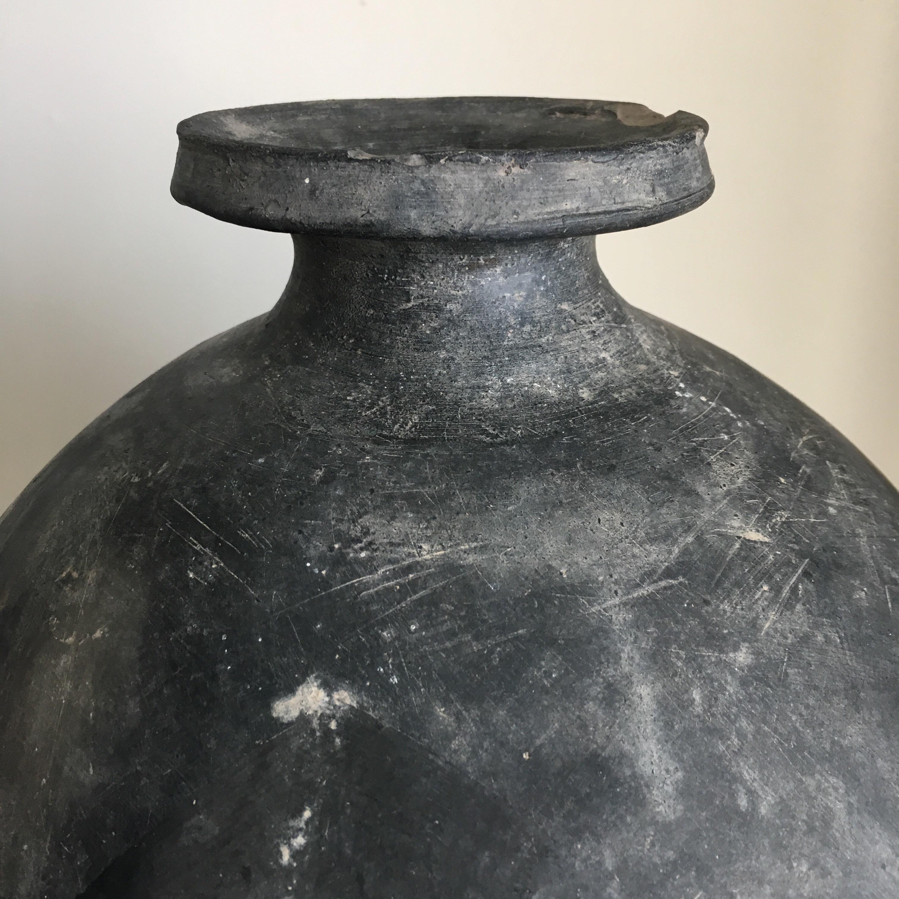 Ceramic mezcal pot from San Bartolo Coyotepec, Oaxaca, Mexico. Engraved 1957. Used to transport mezcal or pulque by way of donkey from harvest villages. Its egg-shape ensures the highest strength possible. Black clay is only sourced from San