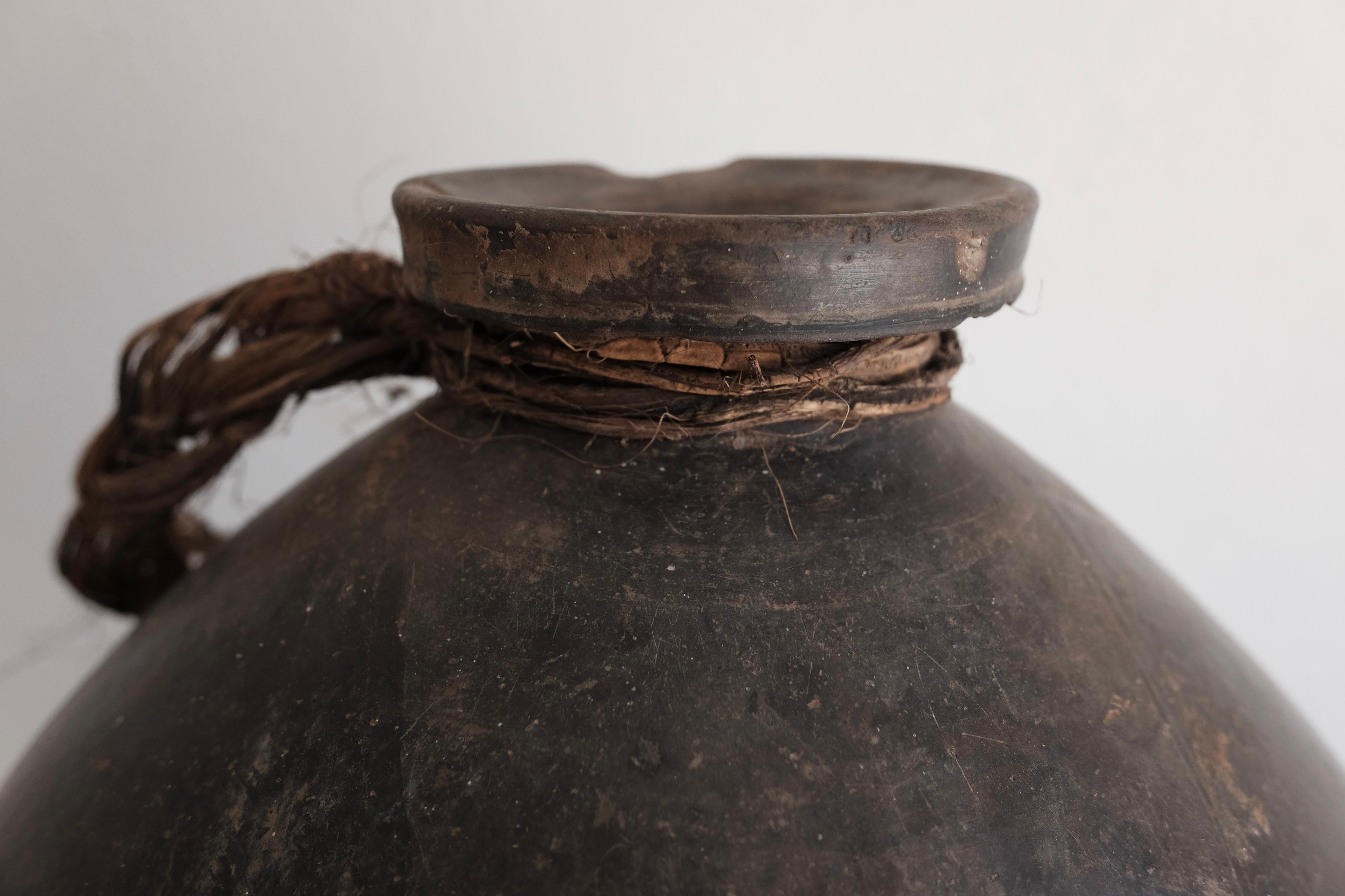 Ceramic mezcal pot from San Bartolo Coyotepec, Oaxaca, Mexico. Used to transport mezcal or pulque by way of donkey from harvest villages. Its egg-shape ensures the highest strength possible. Black clay is only sourced from San Bartolo. The art form
