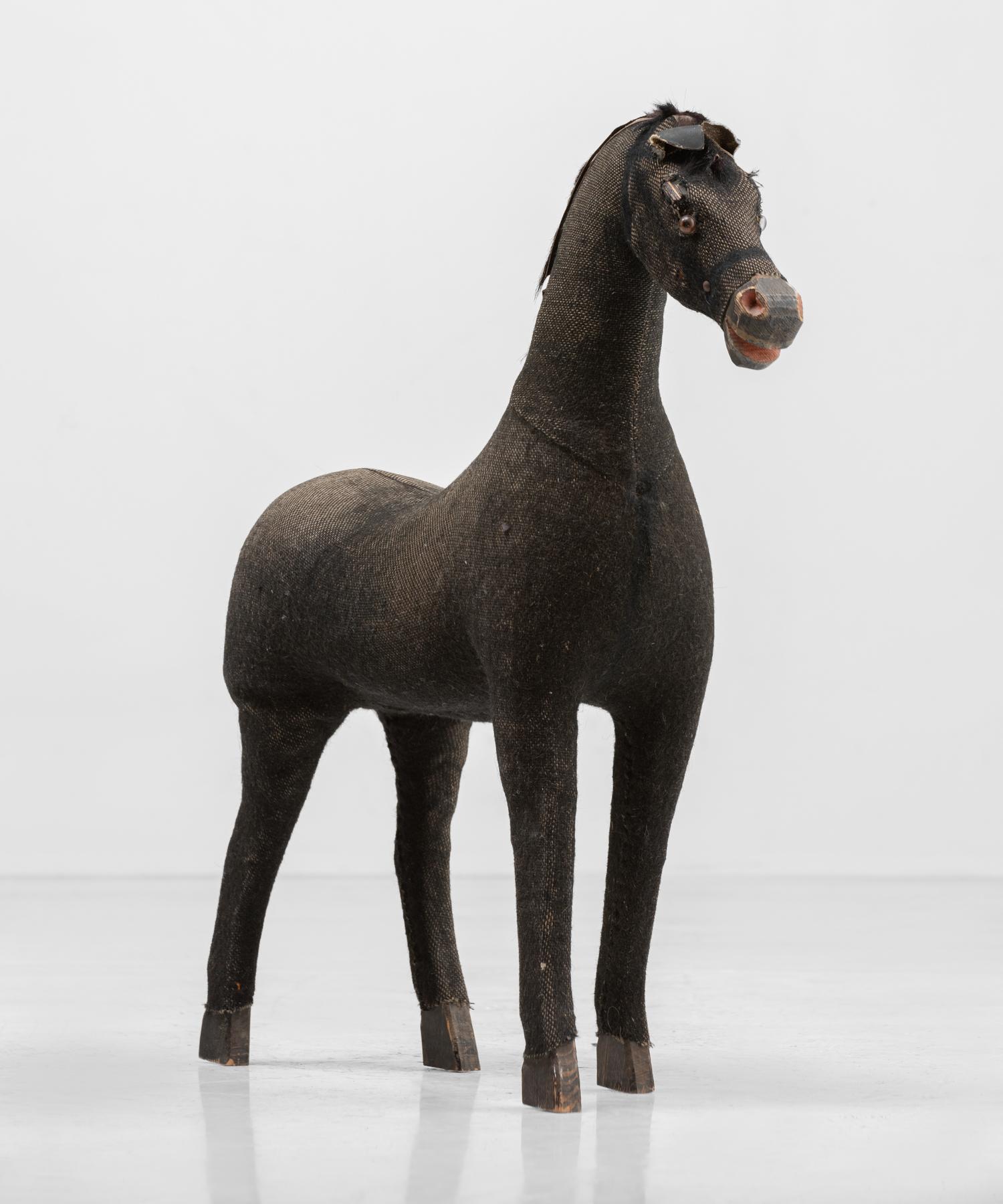 Black Cloth Horse, circa 1890

Petite horse, hand-sewn of a black textured fabric, includes wooden details.