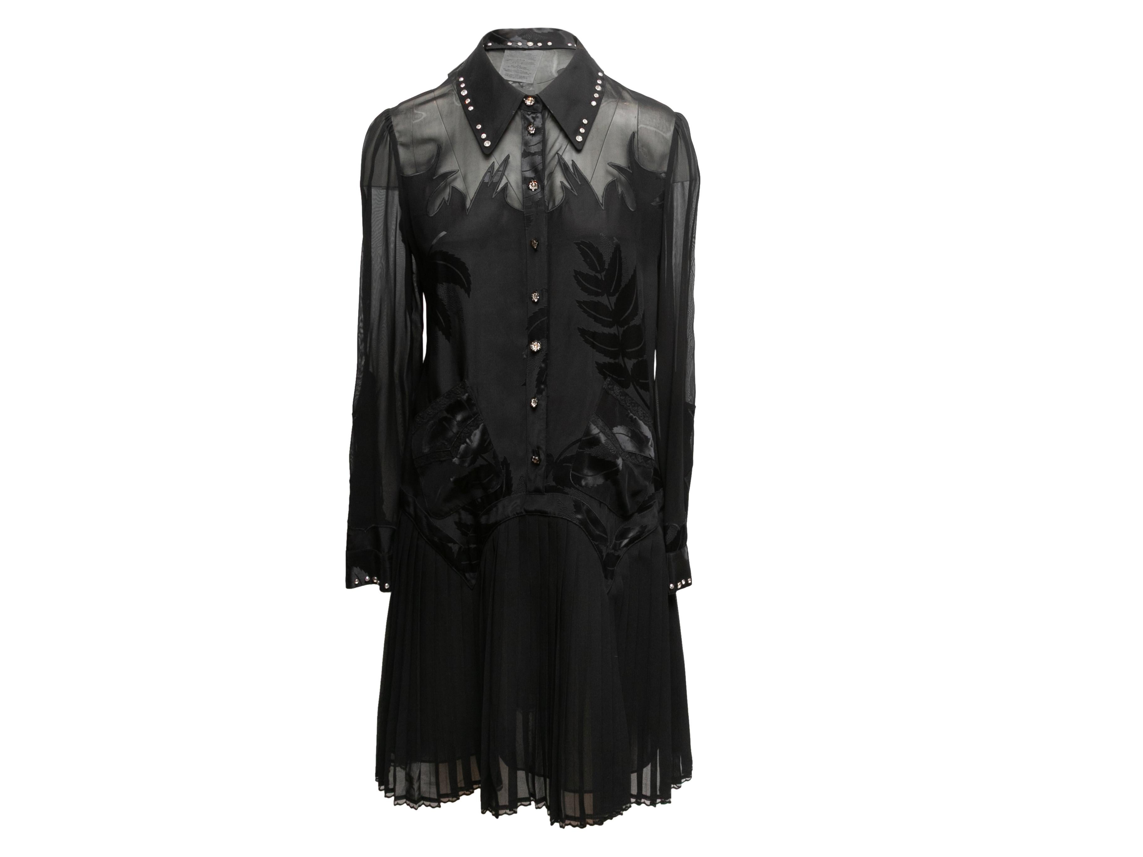 Product Details: Black semi-sheer long sleeve dress by Coach 1941. Pointed collar featuring crystal embellishments. Crystal embellishments at cuffs. Leaf motif at bodice. Pleated skirt. Button closures at center front. 36