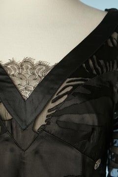 Black cocktail dress in satin dévoré, ruffles and lace Galliano