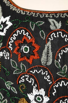 Black cocktail dress with beaded work un the bust Circa 1960's