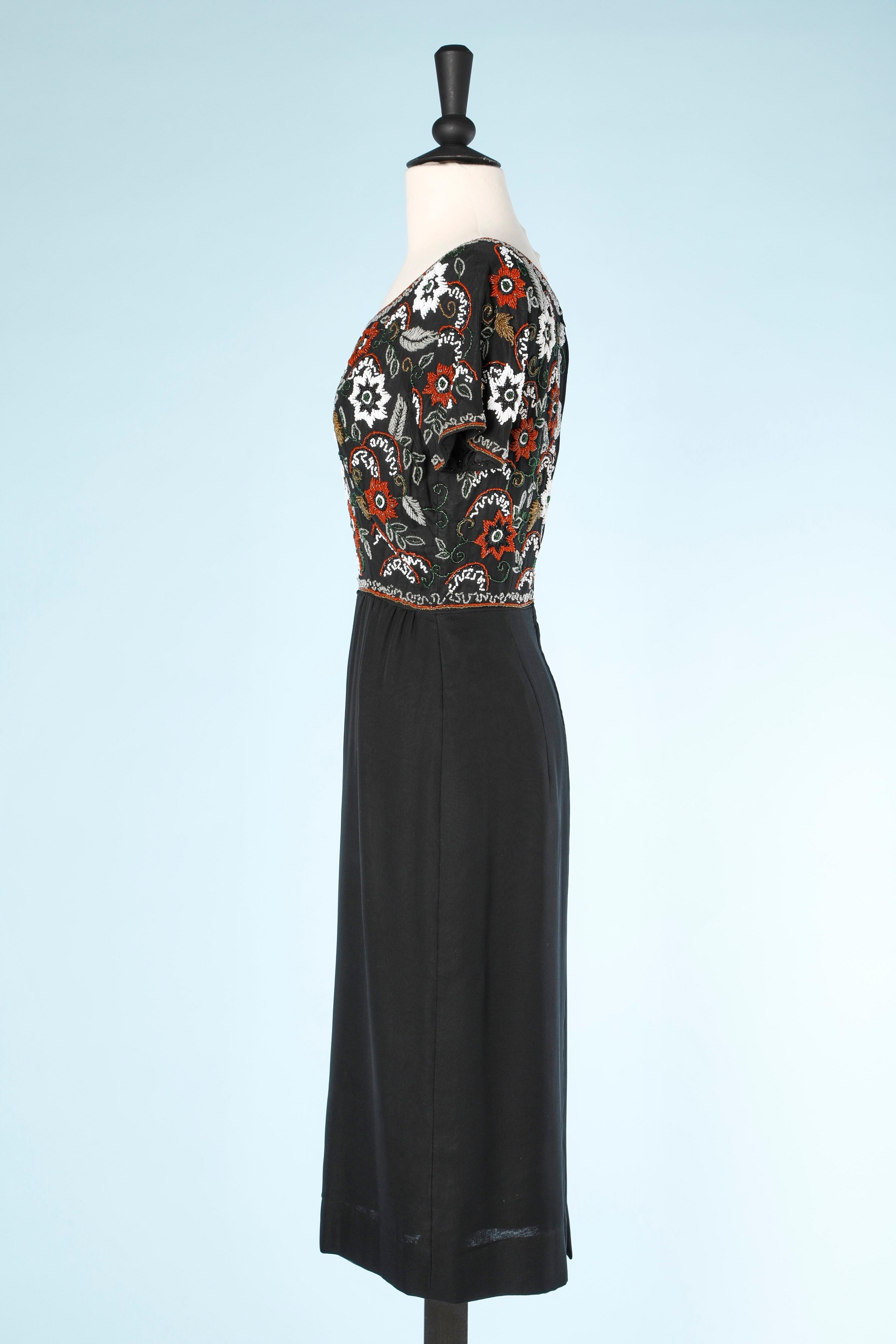 Black cocktail dress with beaded work un the bust Circa 1960's  In Excellent Condition For Sale In Saint-Ouen-Sur-Seine, FR