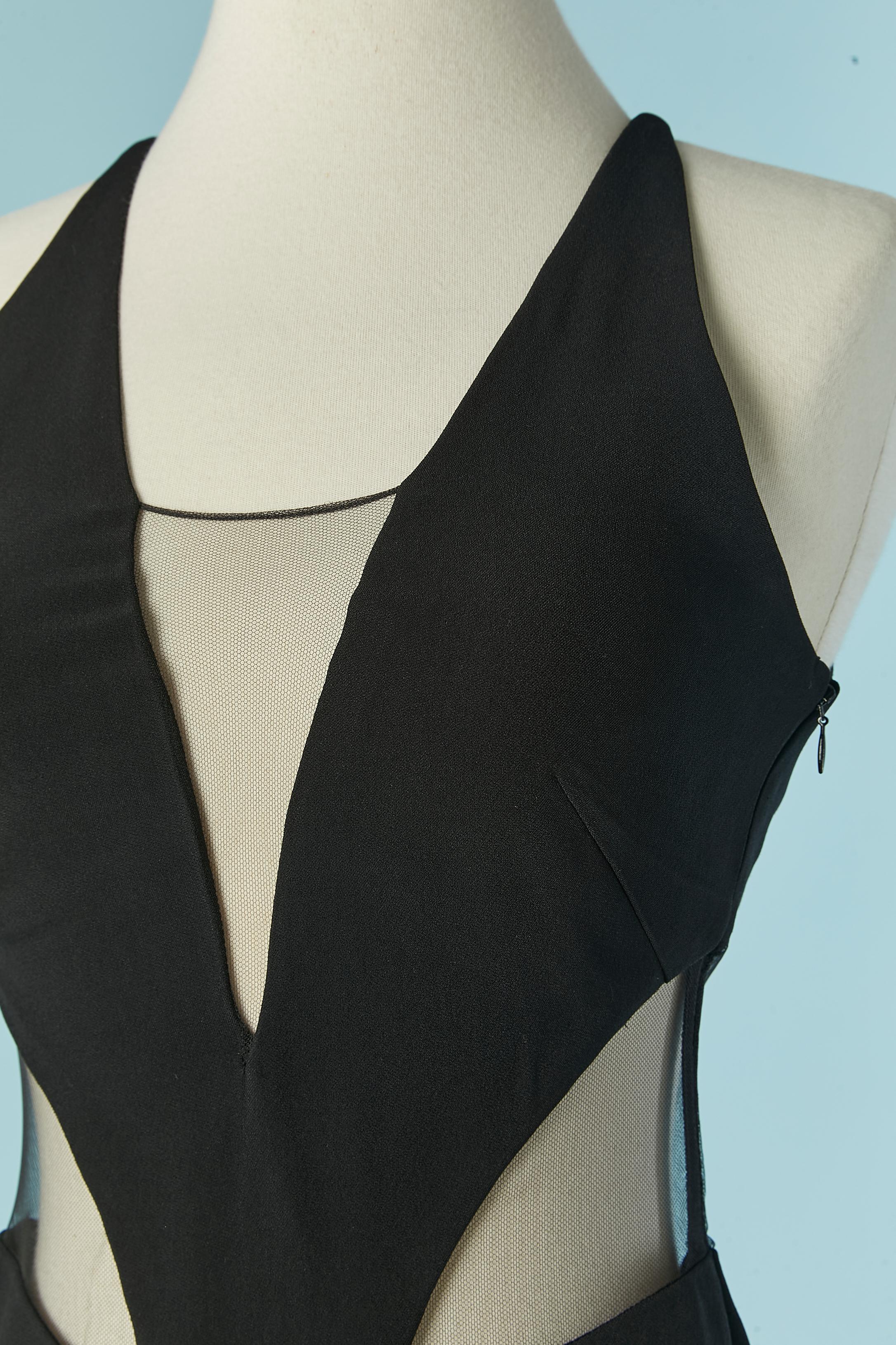 Black cocktail dress with cut-work and see-through tulle. The fabric composition tag has been cut but the black fabric is probably in rayon and the tulle in polyester. 
Invisible zip on the left side. Cut-work. 
Total lenght middle front =