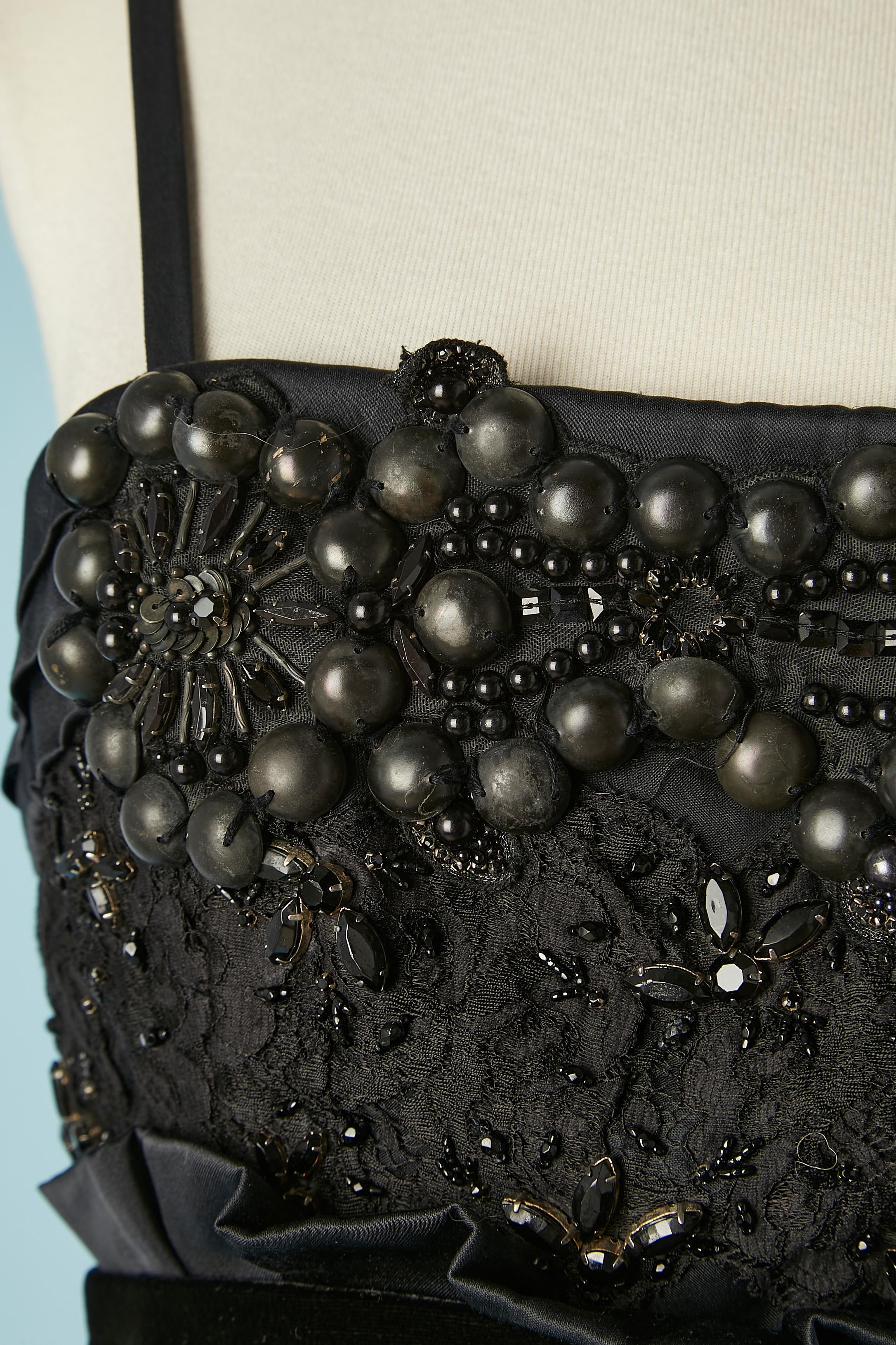 Black cocktail dress with lace, beads and velvet belt. Fabric composition: silk, rayon, cotton, nylon , lace, glass beads and metal beads.
Silk lining. 
Zip and hook&eye middle back. Boned on the side of the bustier and silicone stripe on the top