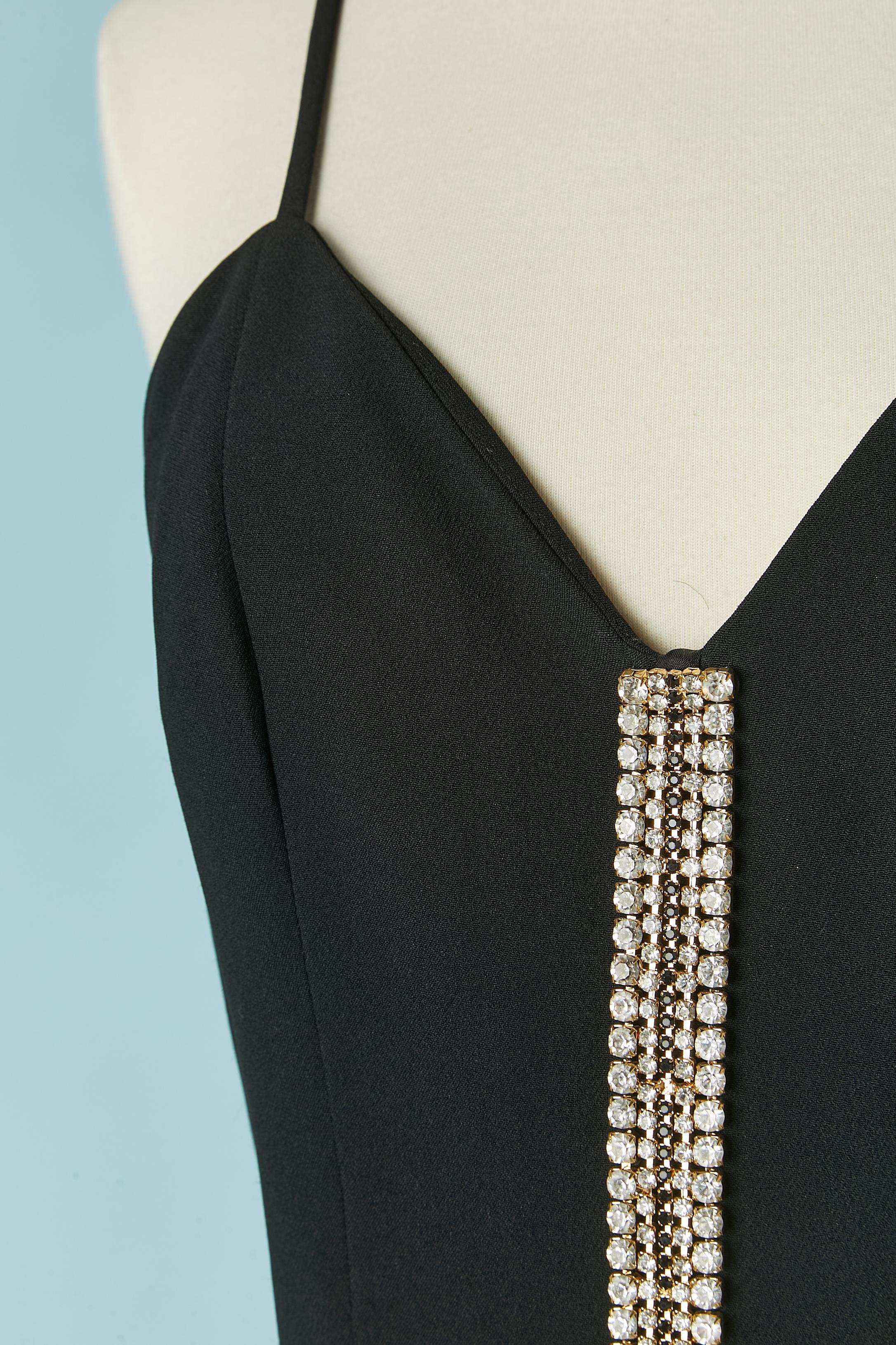Black cocktail dress with rhinestone embellishment. Shell fabric composition: 58% acetate, 42% rayon. Lining composition: 60% acetate, 40% cupro. 
Zip closure on the middle back + hook&eye. 
Split on the middle back, lenght: 9cm

SIZE 46 (It) 42
