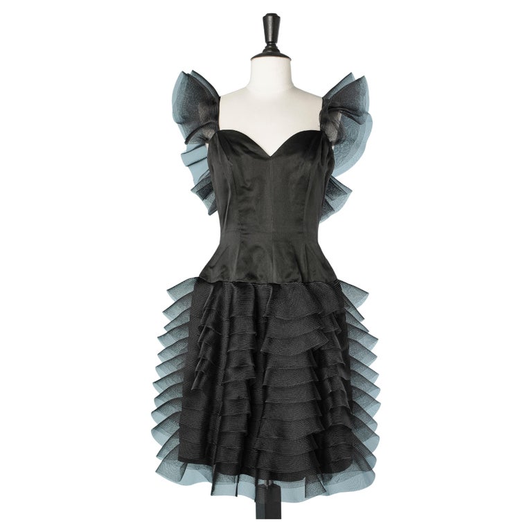 Black cocktail dress with stiff fabric ruffles on shoulders and skirt