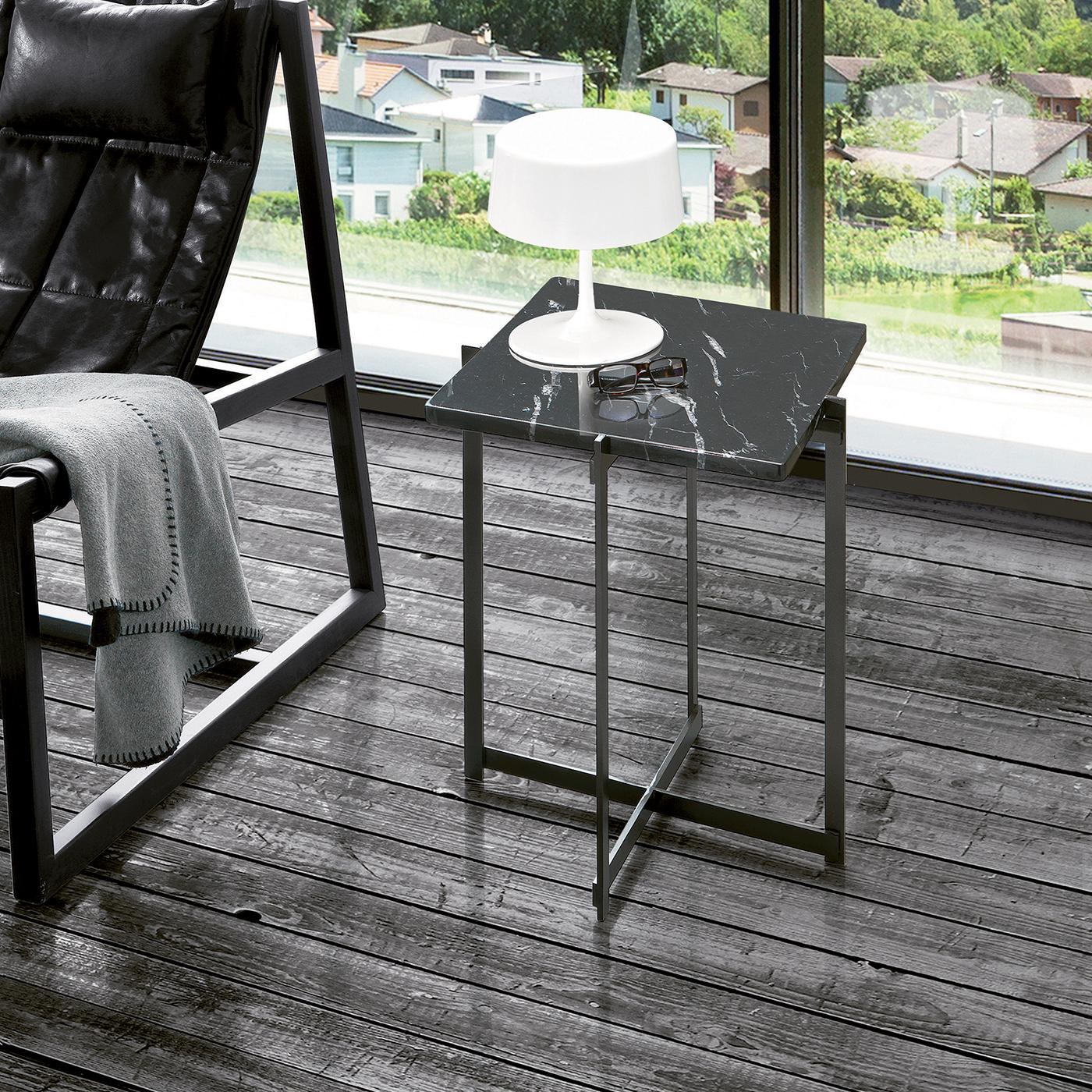 Polyvalente et minimaliste, cette table basse est parfaite pour exposer une lampe près d'un canapé ou des livres ou des boissons à côté d'un fauteuil de salon. La structure de cette pièce bien nommée est en métal teinté noir avec un motif croisé qui