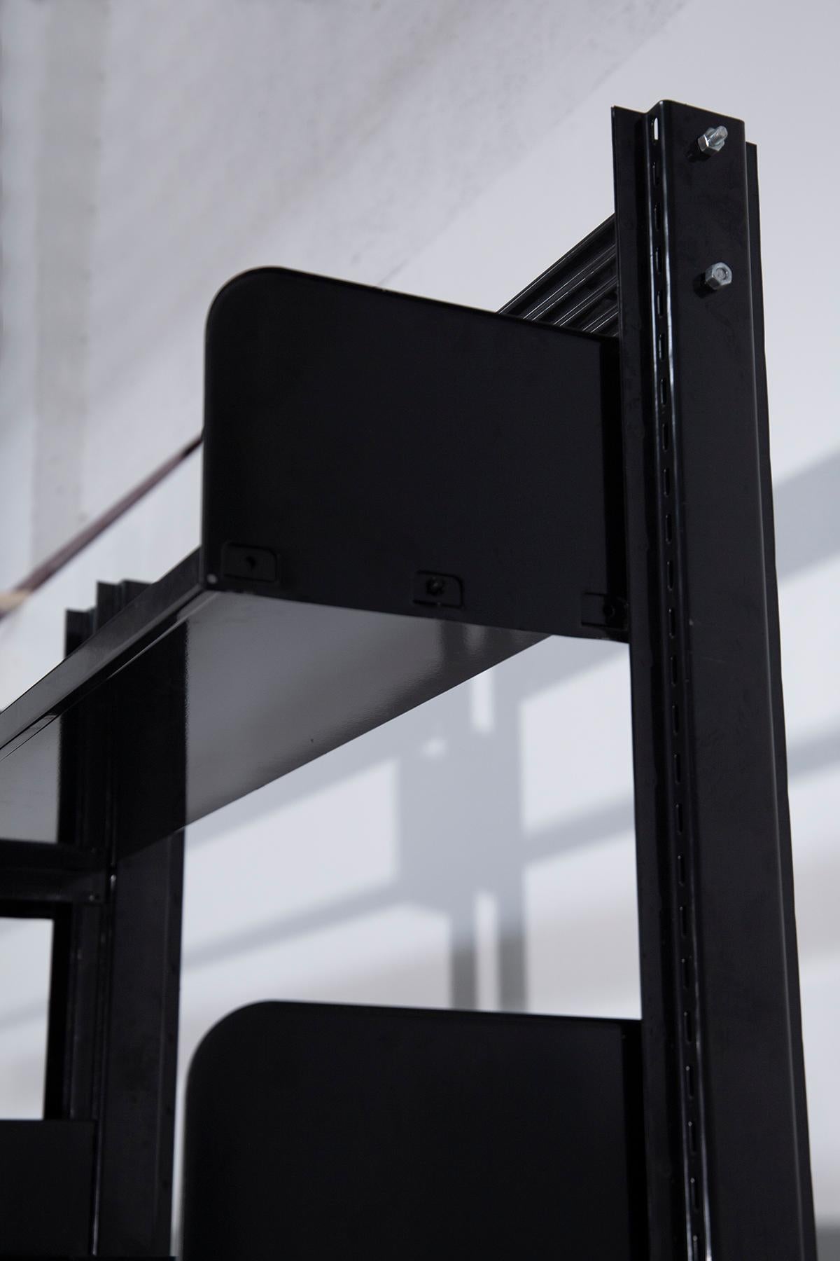 Lips Vago's trio of black Congress bookcases from the 1960s exude an aura of timeless sophistication and functional elegance. These bookcases, made of elegant black painted metal, are iconic symbols of the ingenuity and practicality of design from