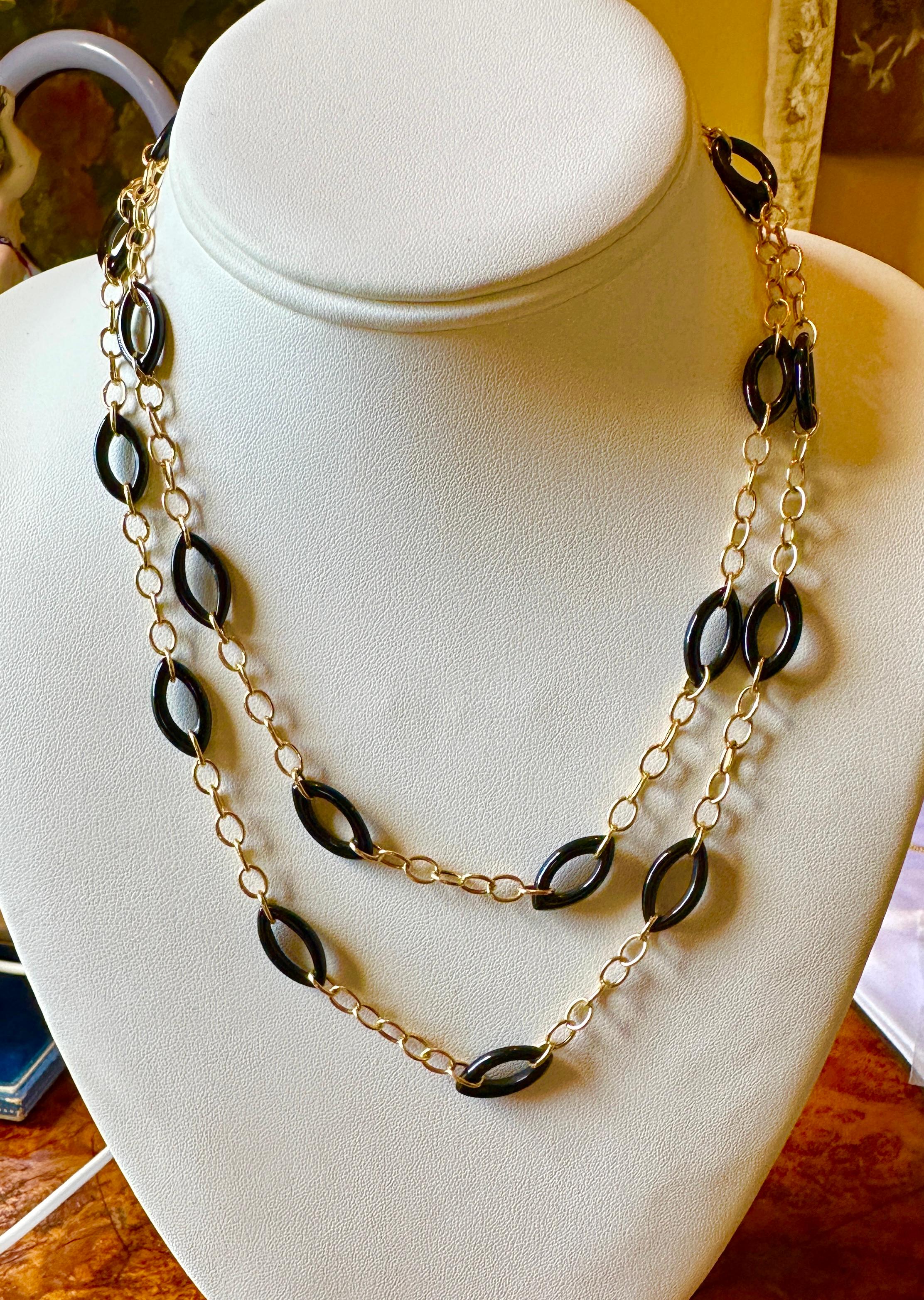 Indulge in this Black Coral and 14 Karat Yellow Gold Link Necklace.  The fabulous Black Coral Necklace is 36 inches long!  The stunning oval Black Coral links are interspersed with 14 Karat Yellow Gold links to create a wonderful long statement