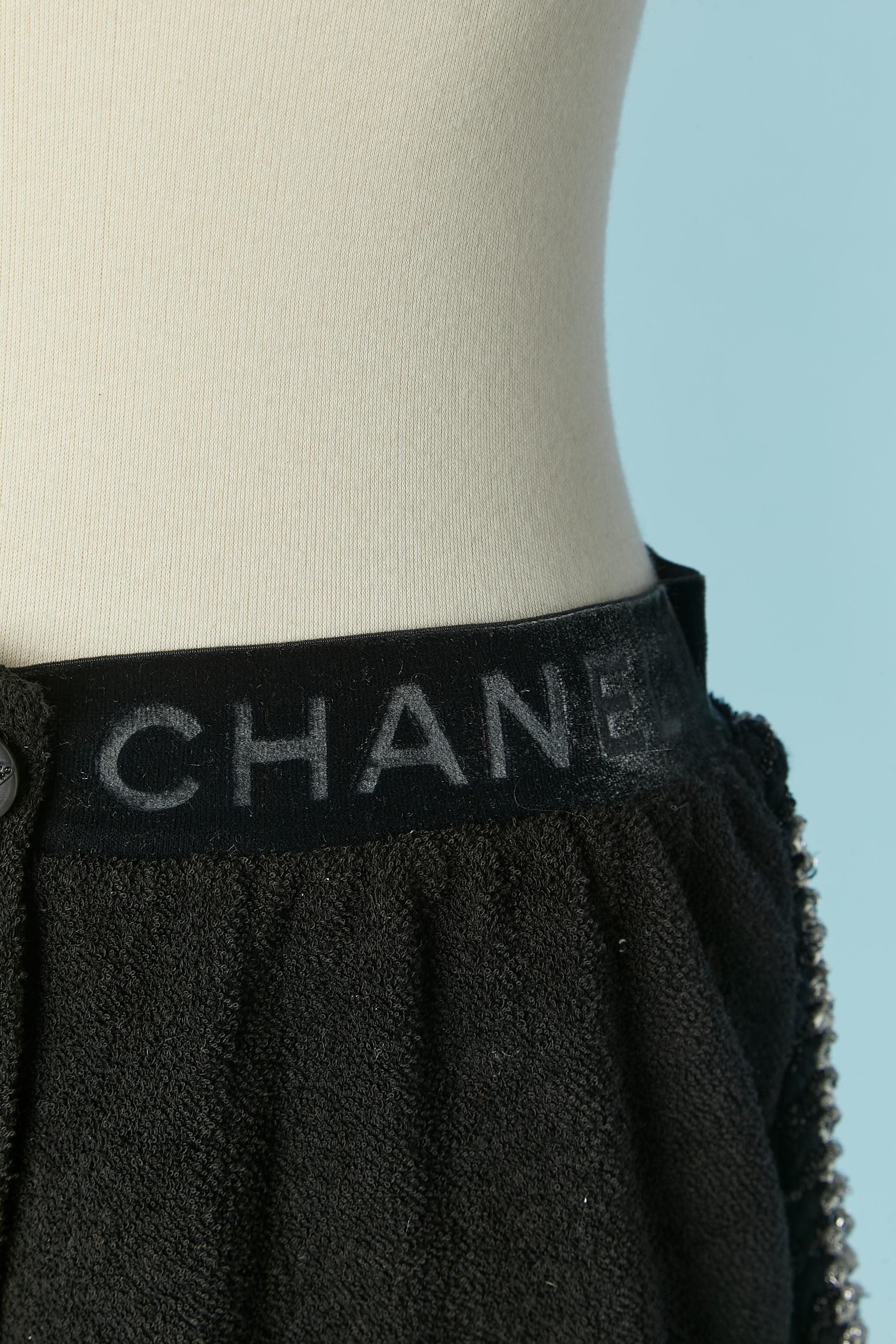 Black cotton eponge short with black and silver lurex braid edge. No fabric composition tag. Silk lining inside the back pocket. Split on both side. Branded button and buttonhole closure on the middle front. Branded elastic velvet waist band. 
SIZE