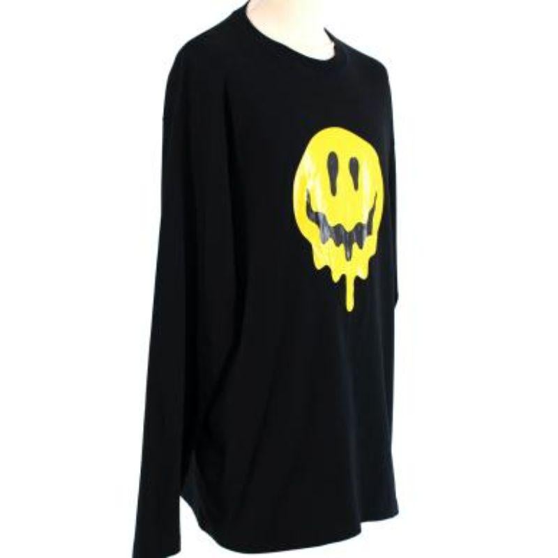 Balenciaga black cotton jersey smiley face long sleeve top
 
 - Long sleeve, classic cut long sleeve jersey top
 - Printed smiley face front logo
 - Embroidered skeleton hand at the nape 
 
 Materials:
 100% Cotton
  Embroidery 
  100% Polyester 
 
