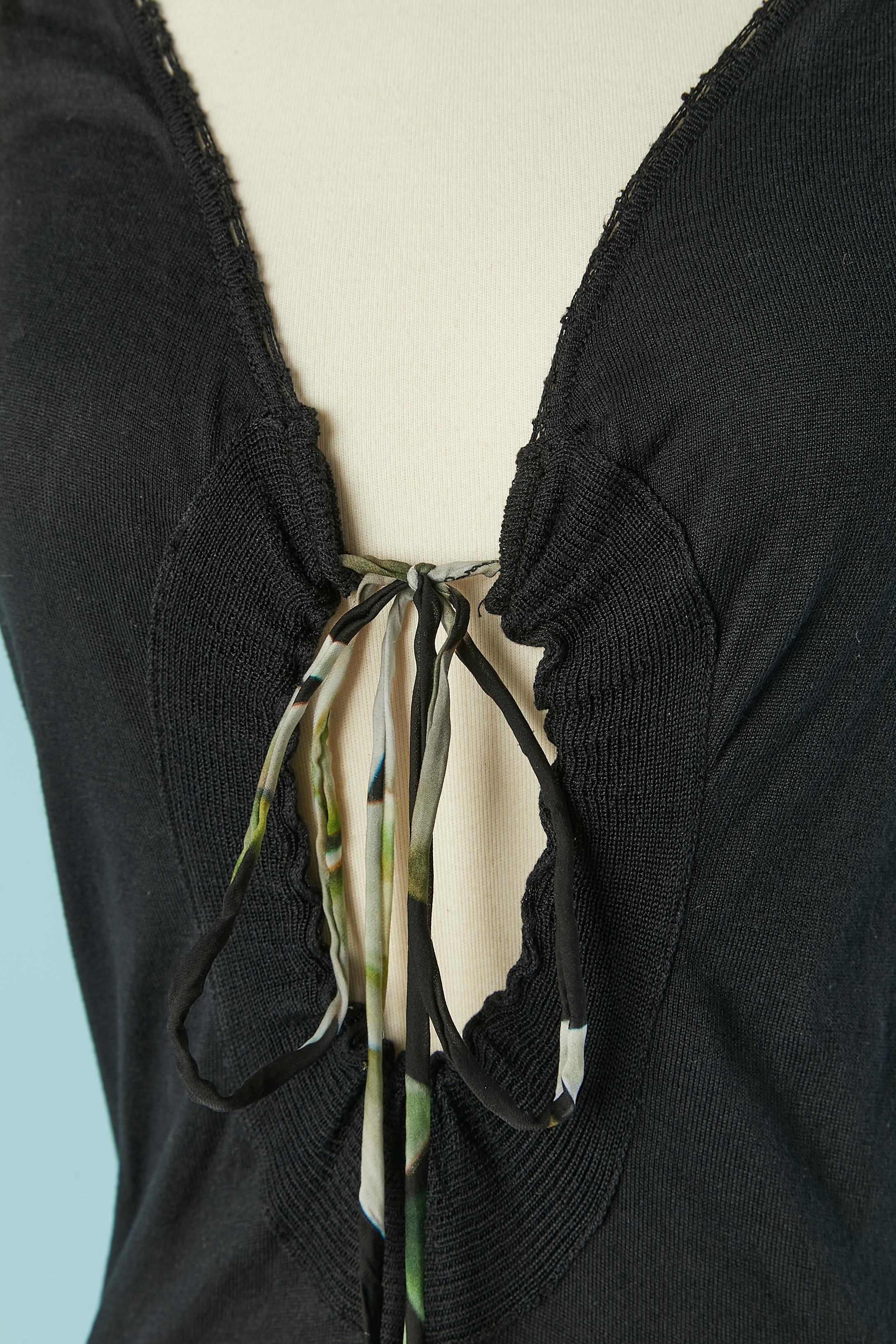 Black cotton knit and printed silk sleeveless dress with drawstring on the neckline and drop. Ruffles on the bottom edge. The fabric composition tag has been cut. Authenticity hologram tag. 
Lenght on the front= 100cm 
Lenght on the back= 115cm