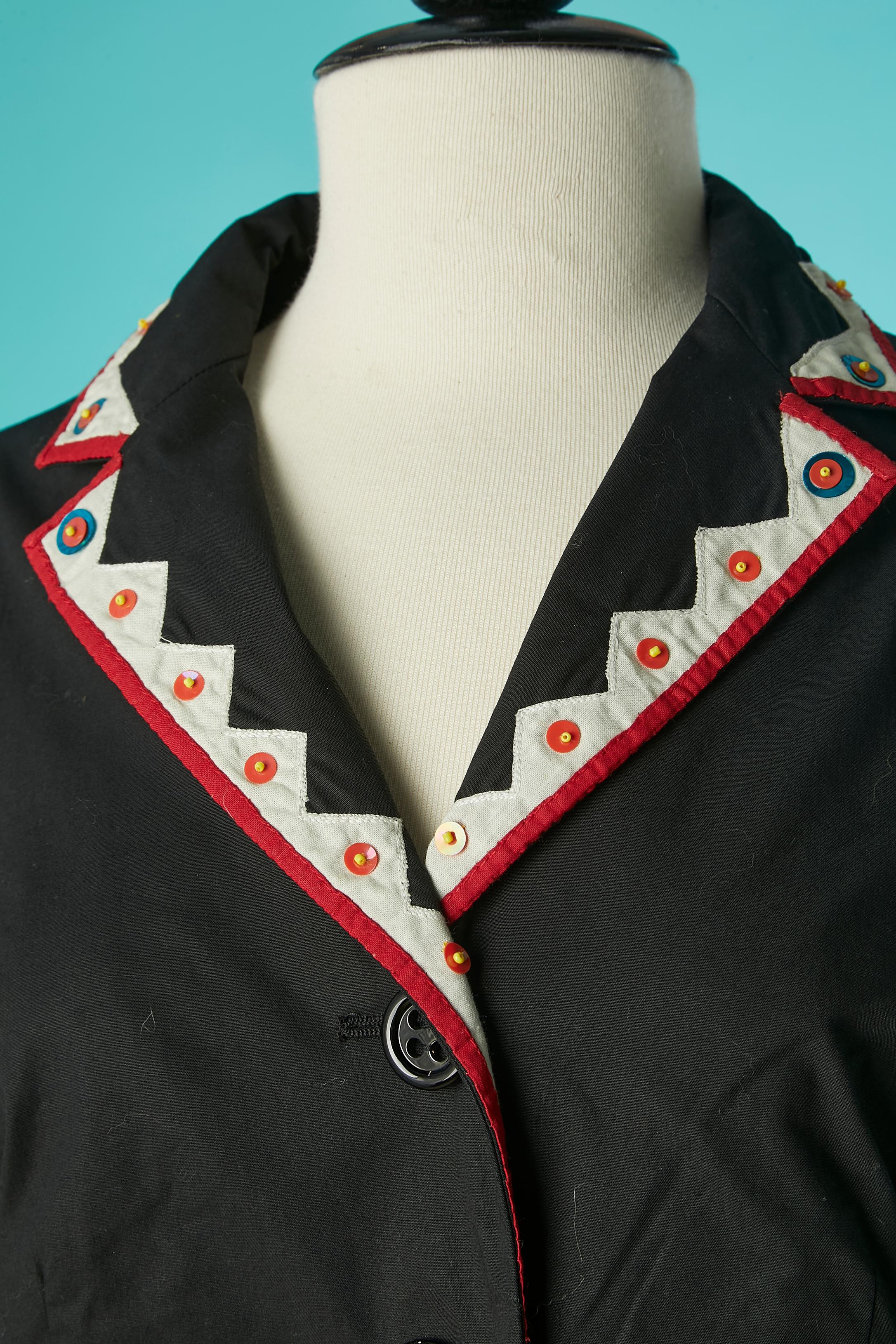 Black cotton skirt suit with fabric and sequins appliqué. Main fabric composition: 96% cotton, 4% other fibers . Lining: 100% cotton. 
Buttons and buttonholes closure on the middle front. 
SIZE 44 (It) 40 (Fr) 10 (Us) L 