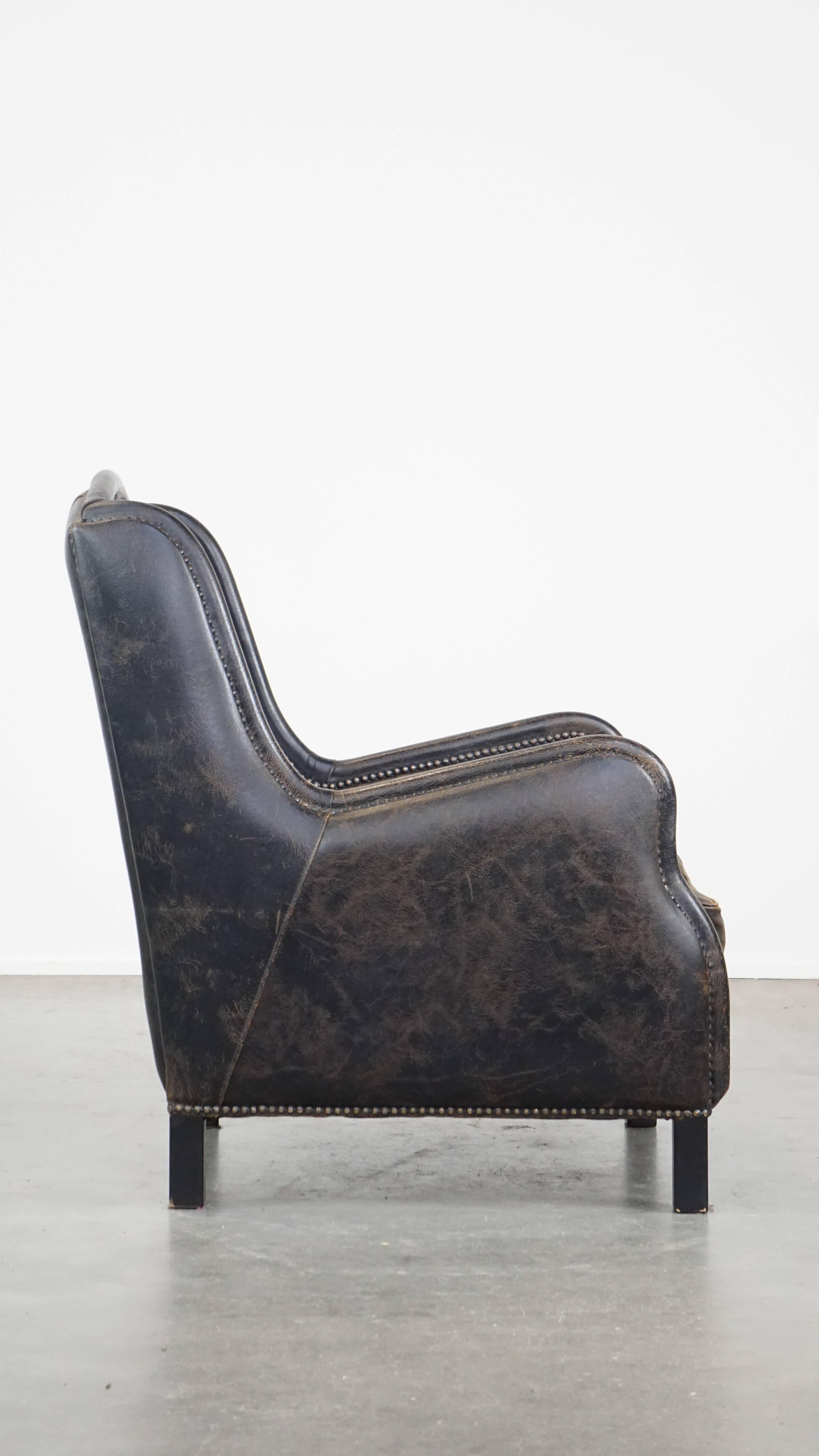Industrial Black cow leather armchair finished with decorative nails, industrial style For Sale
