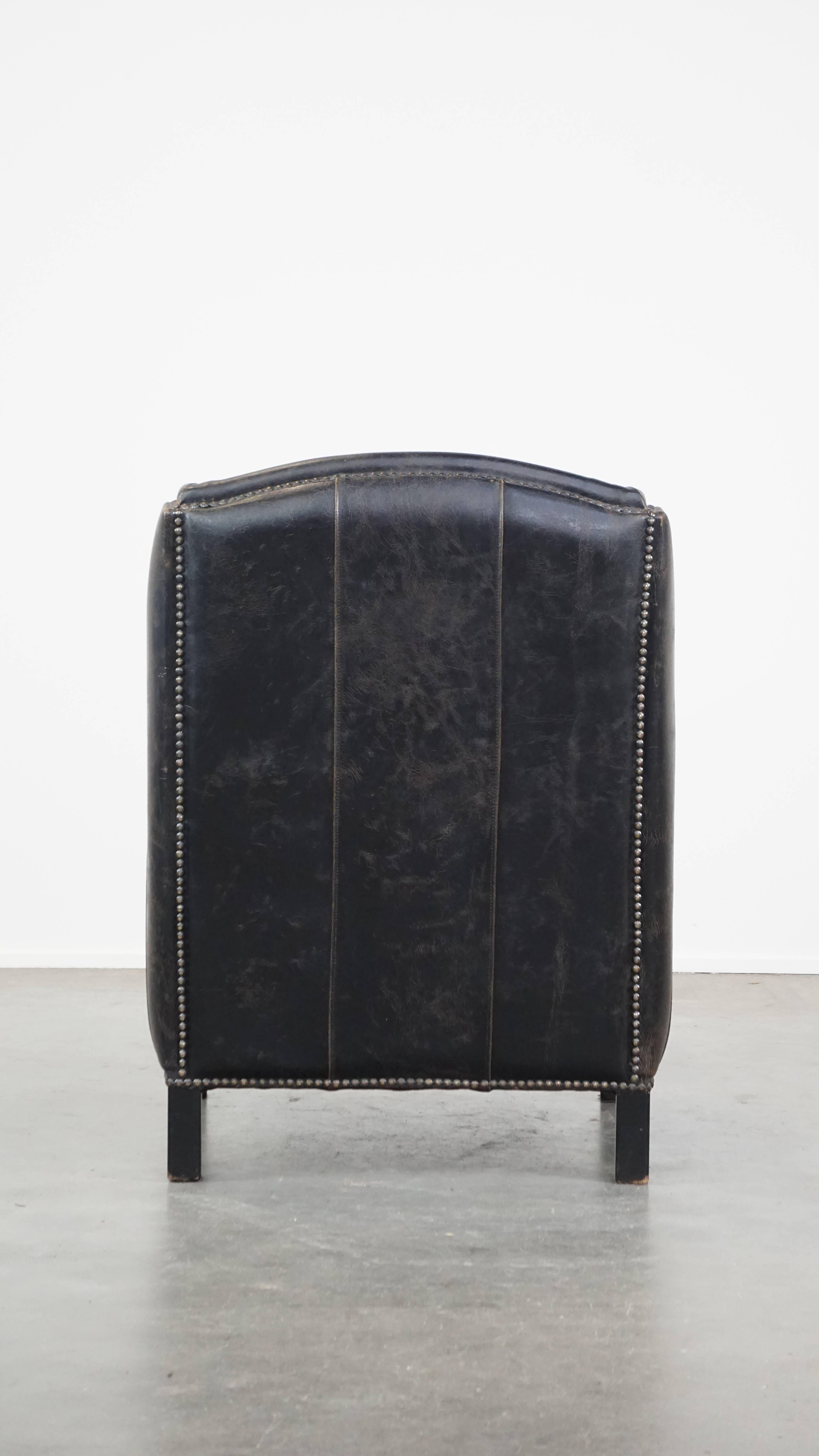 Hand-Crafted Black cow leather armchair finished with decorative nails, industrial style For Sale