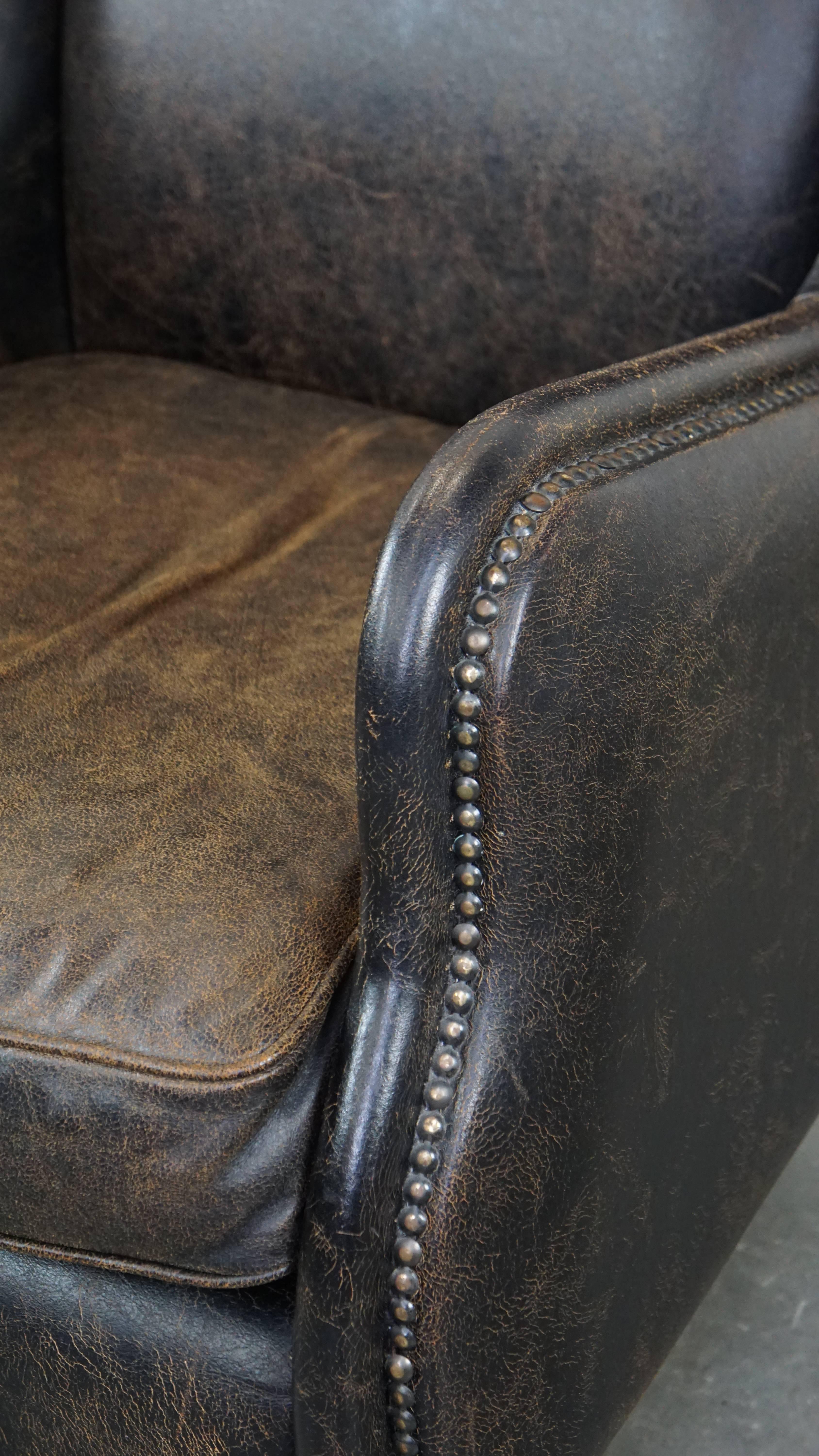 Black cow leather armchair finished with decorative nails, industrial style For Sale 2