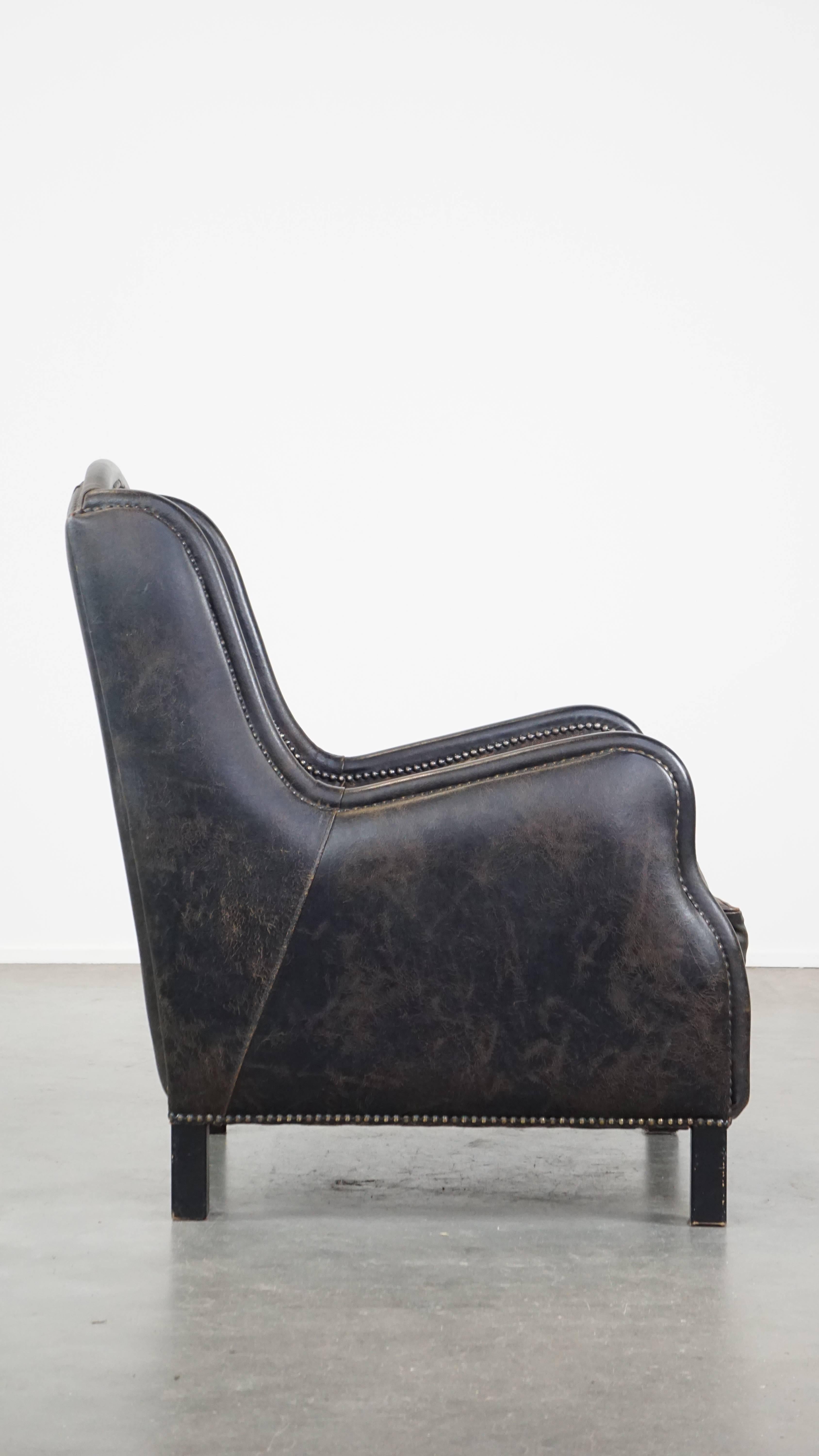 Industrial Black cow leather armchair in industrial style finished with decorative nails For Sale