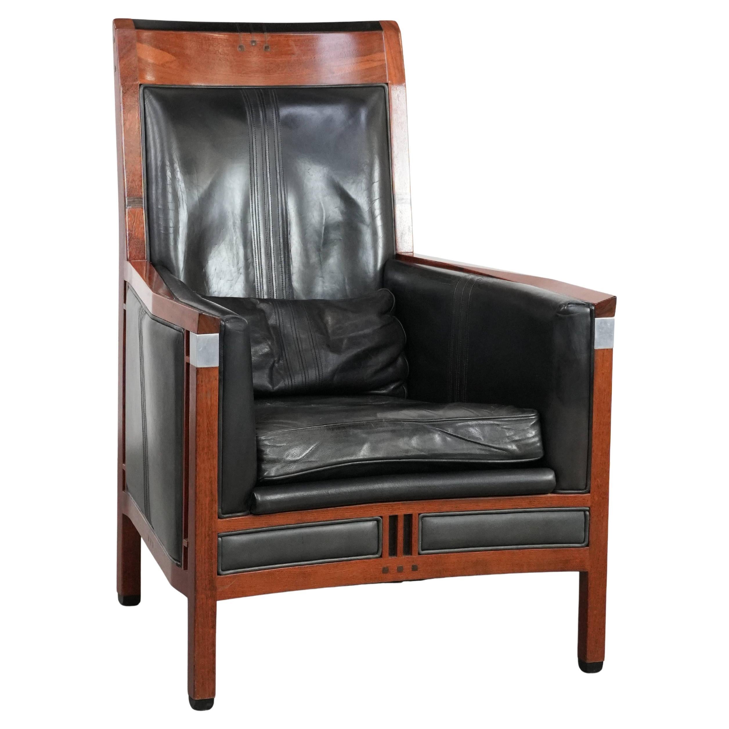 Black cowhide leather and wooden Art Deco design armchair For Sale