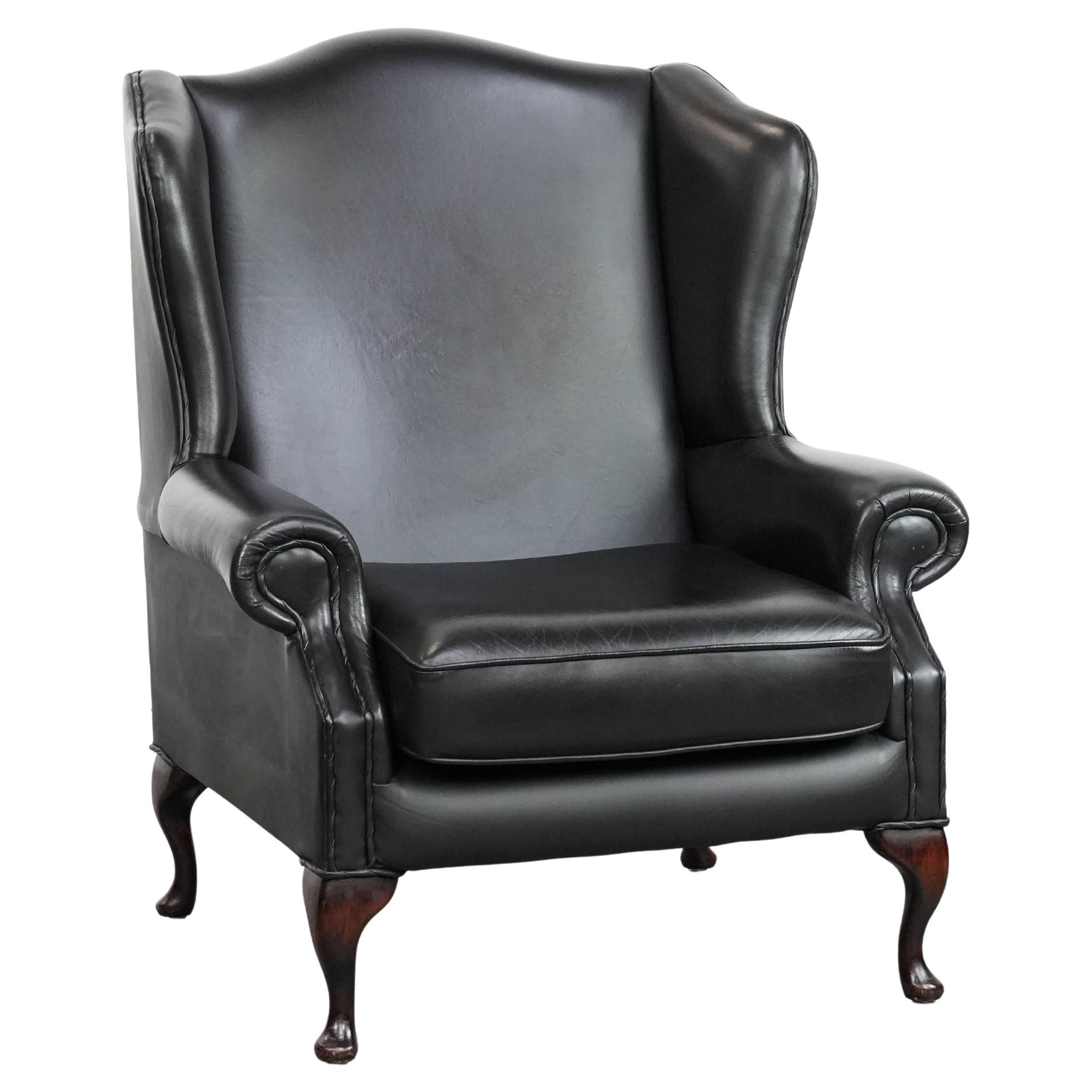 Black cowhide leather Chesterfield wingback chair in English style For Sale