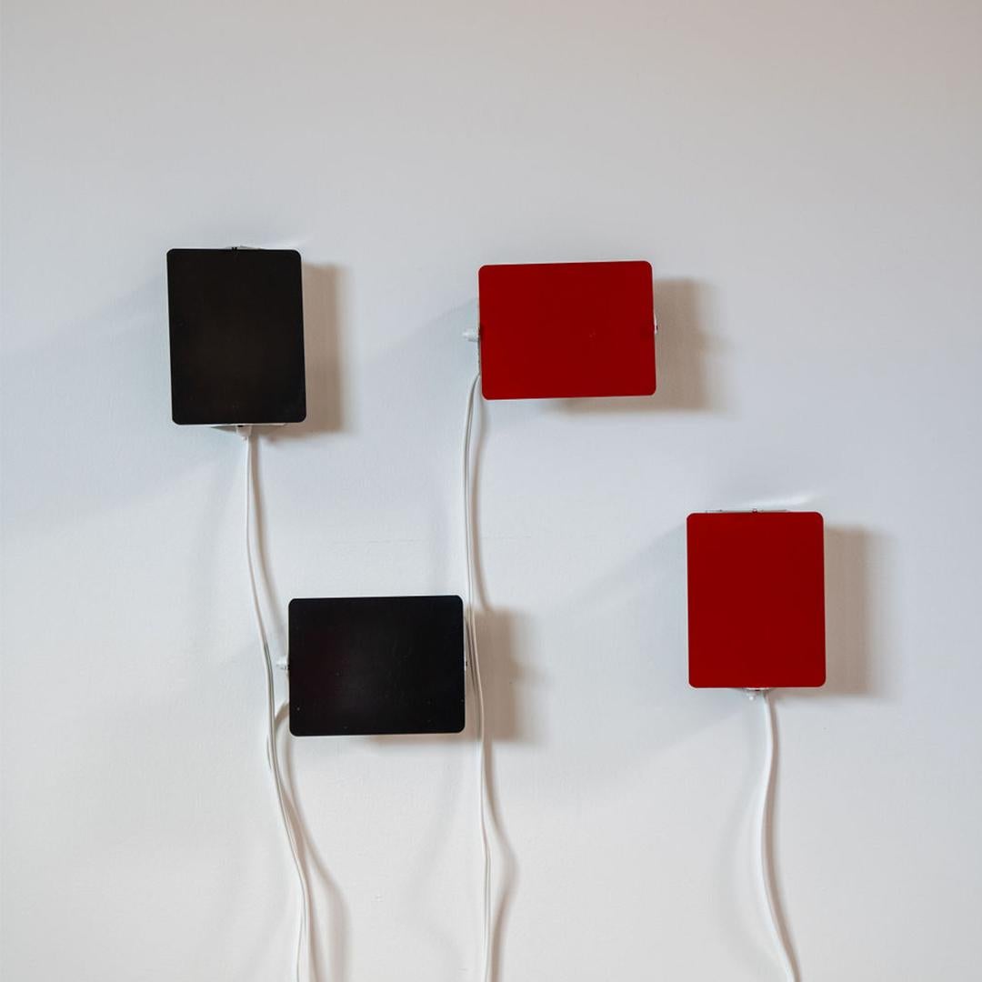 The iconic enameled wall lights by Charlotte Perriand from the 1960’s designed for the apartments of the ski resort Les Arcs in the French Alps (sold individually). 

Its adjustable reflectors, can be mounted horizontally or vertically. Marked