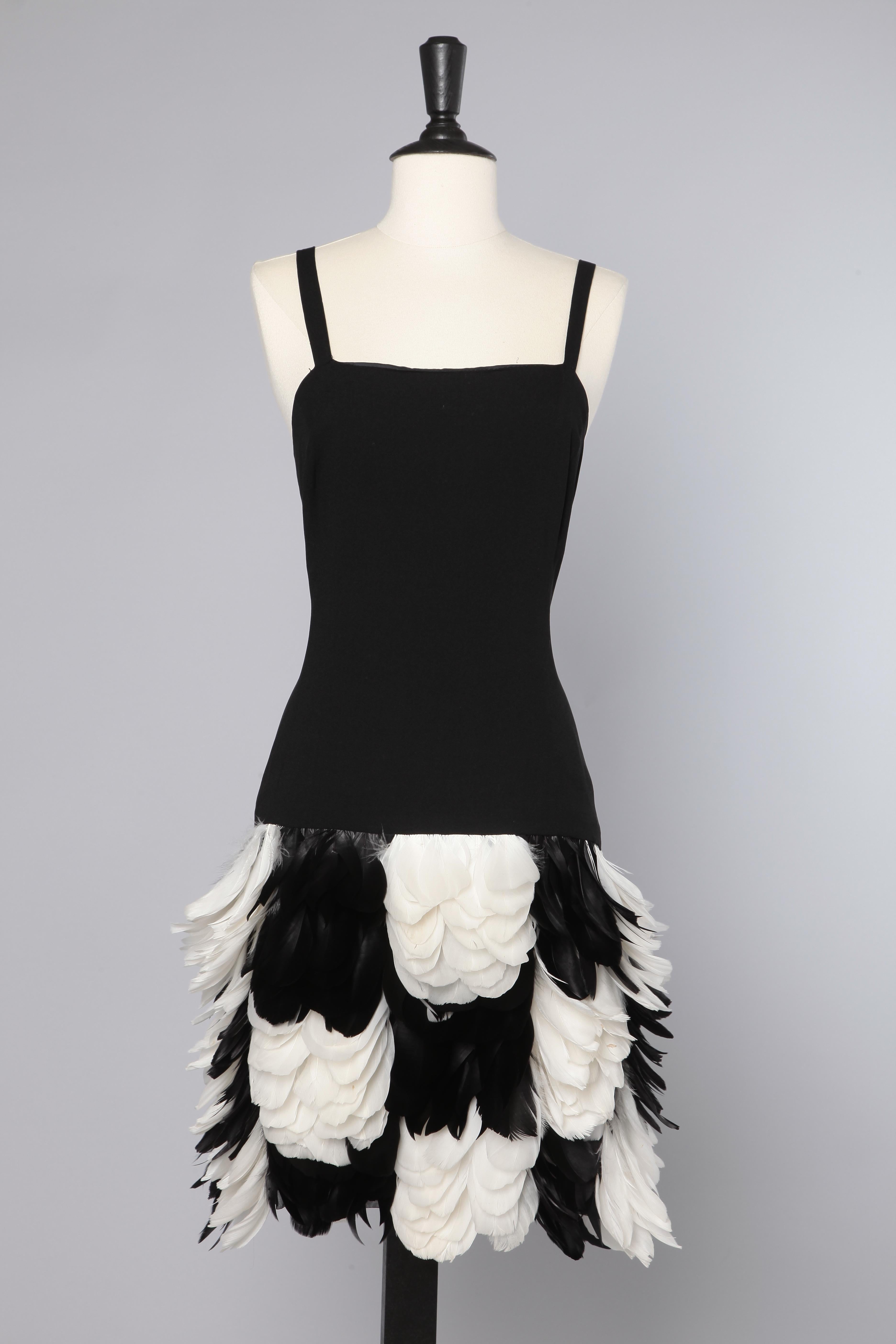 Black crêpe dress with black and white feather and black silk lining. Zipped in the middle back