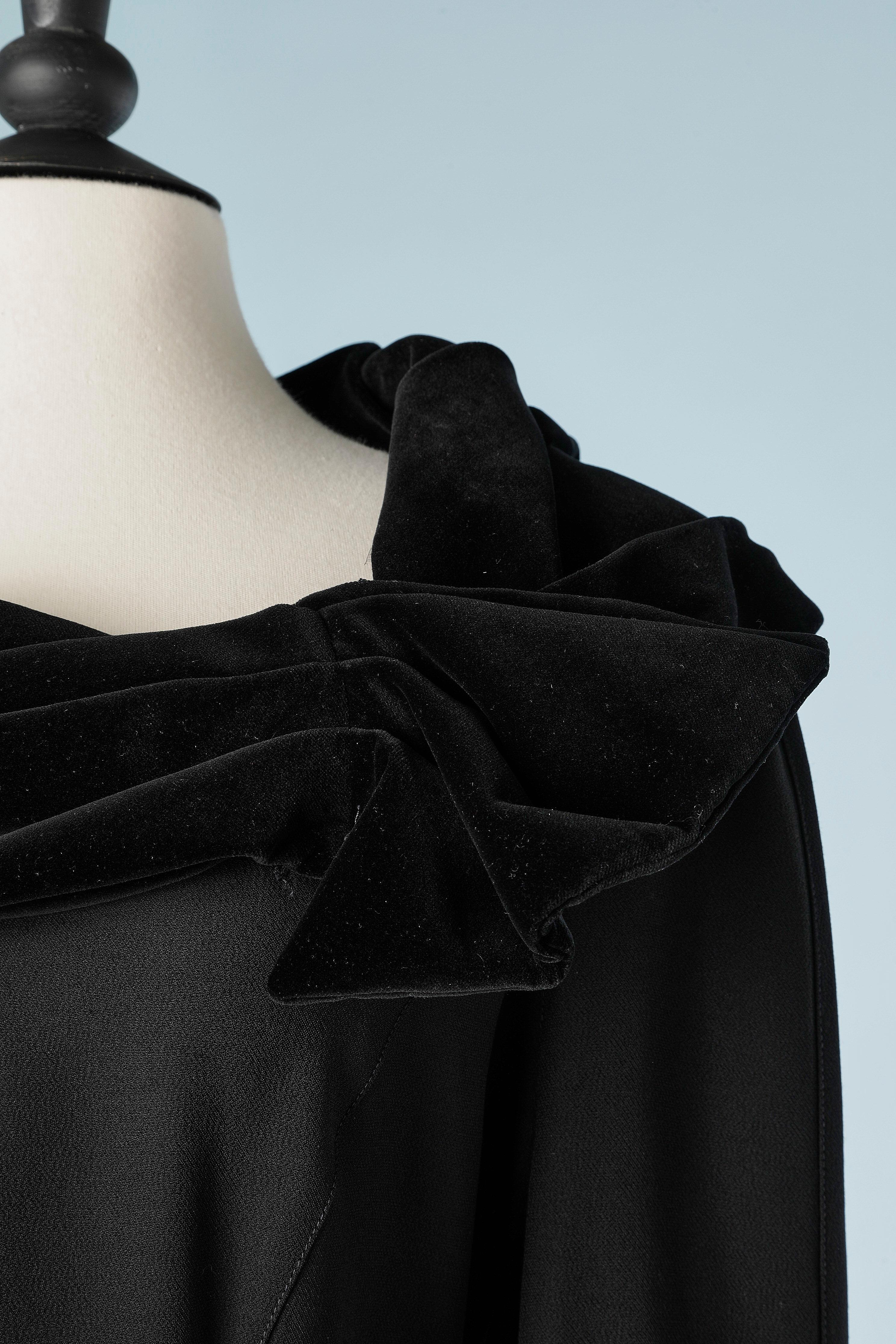 Black crêpe dress with black velvet drape neckline. Snap inside the sleeves. Zip on the back on the side and draped in the middle back. Black velvet lining in the back. Shoulder pad. 
SIZE 40