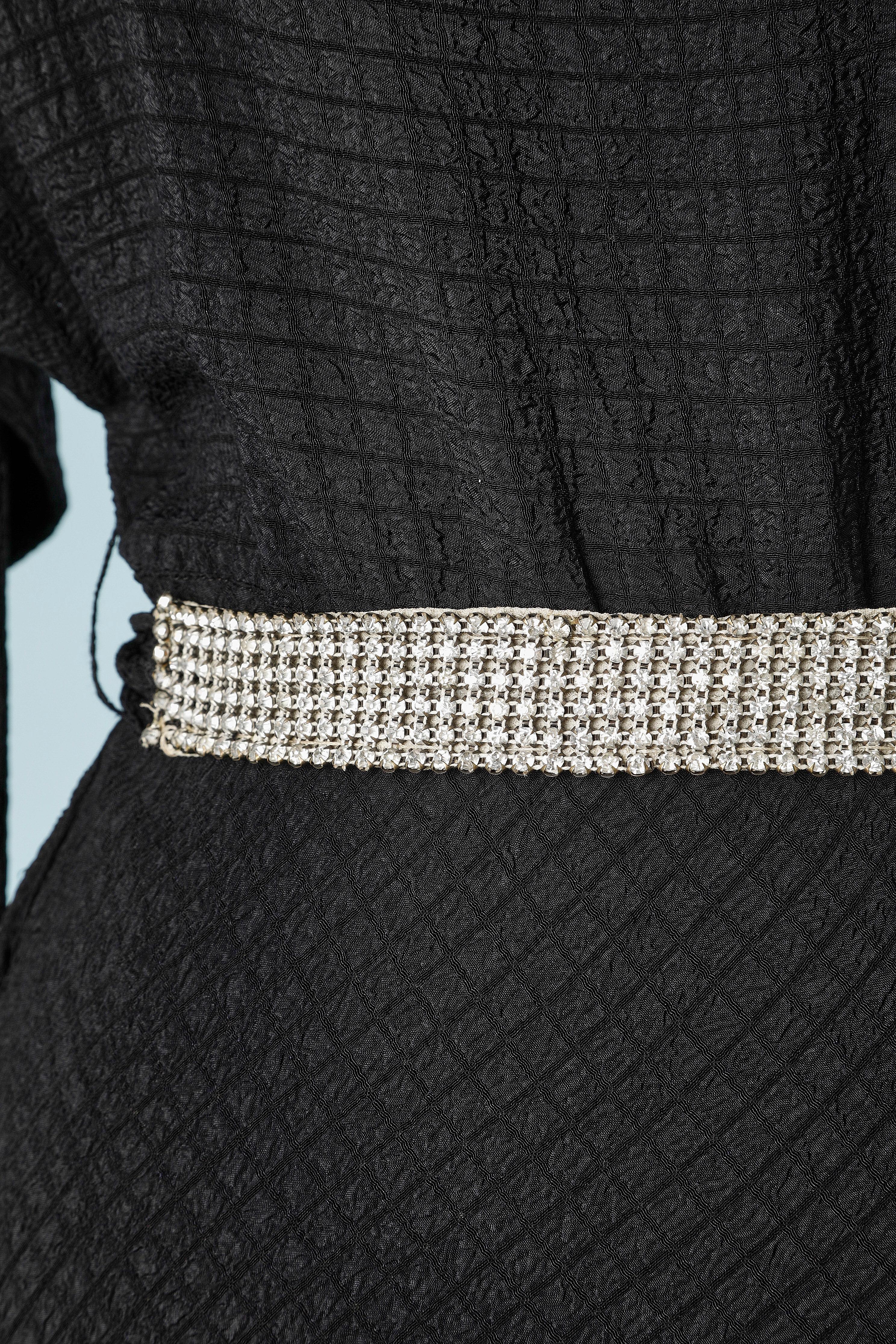 Black crêpe evening dress with rhinestone shoulder-strap and belt . Snap closure on the left side. and belt with rhinestone on. 
SIZE 38/ M 
