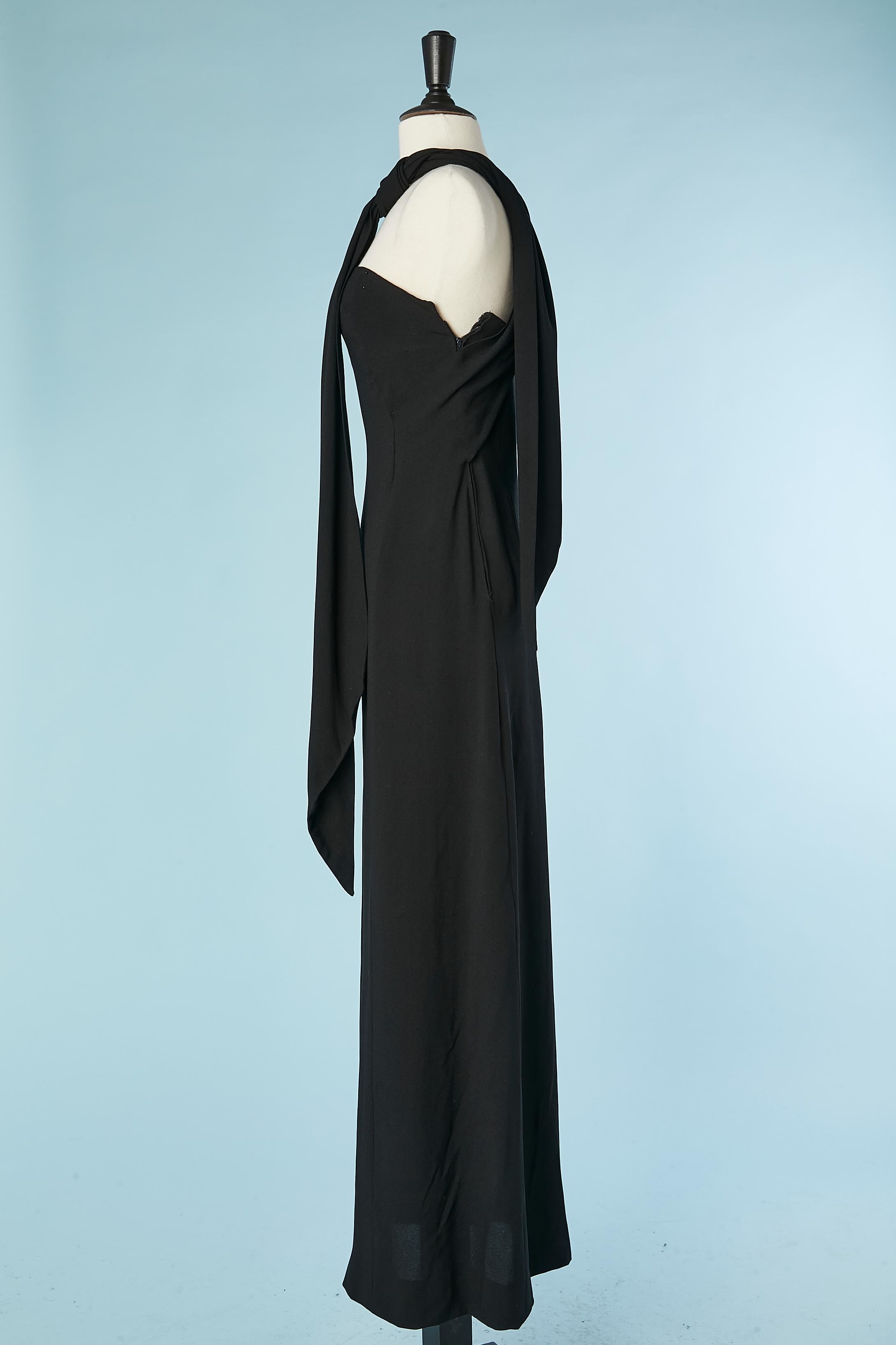 Black crêpe evening dress with scarf . Double lays of crêpe. Zip on the left side. Boned. The both part of the scarves are attached on the waist, then get crossed in the middle back then wrapped around the neck 
SIZE 38 (Fr) M ( but small bust)