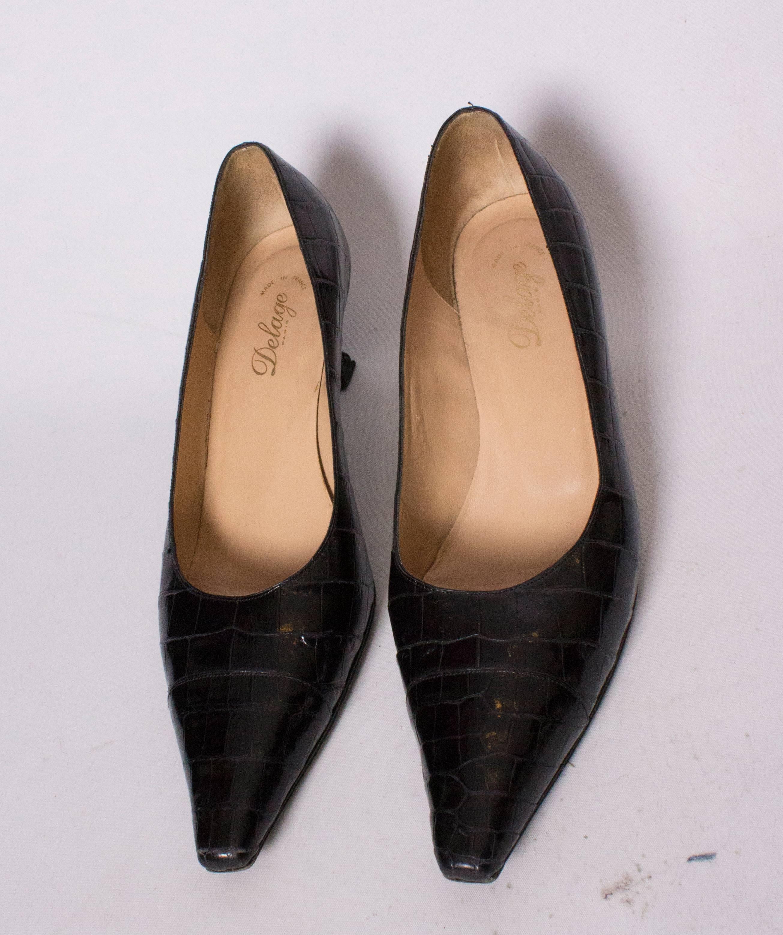 A chic pair of handmade shoes by Delage Paris. In black croc, they are in immaculate condition.