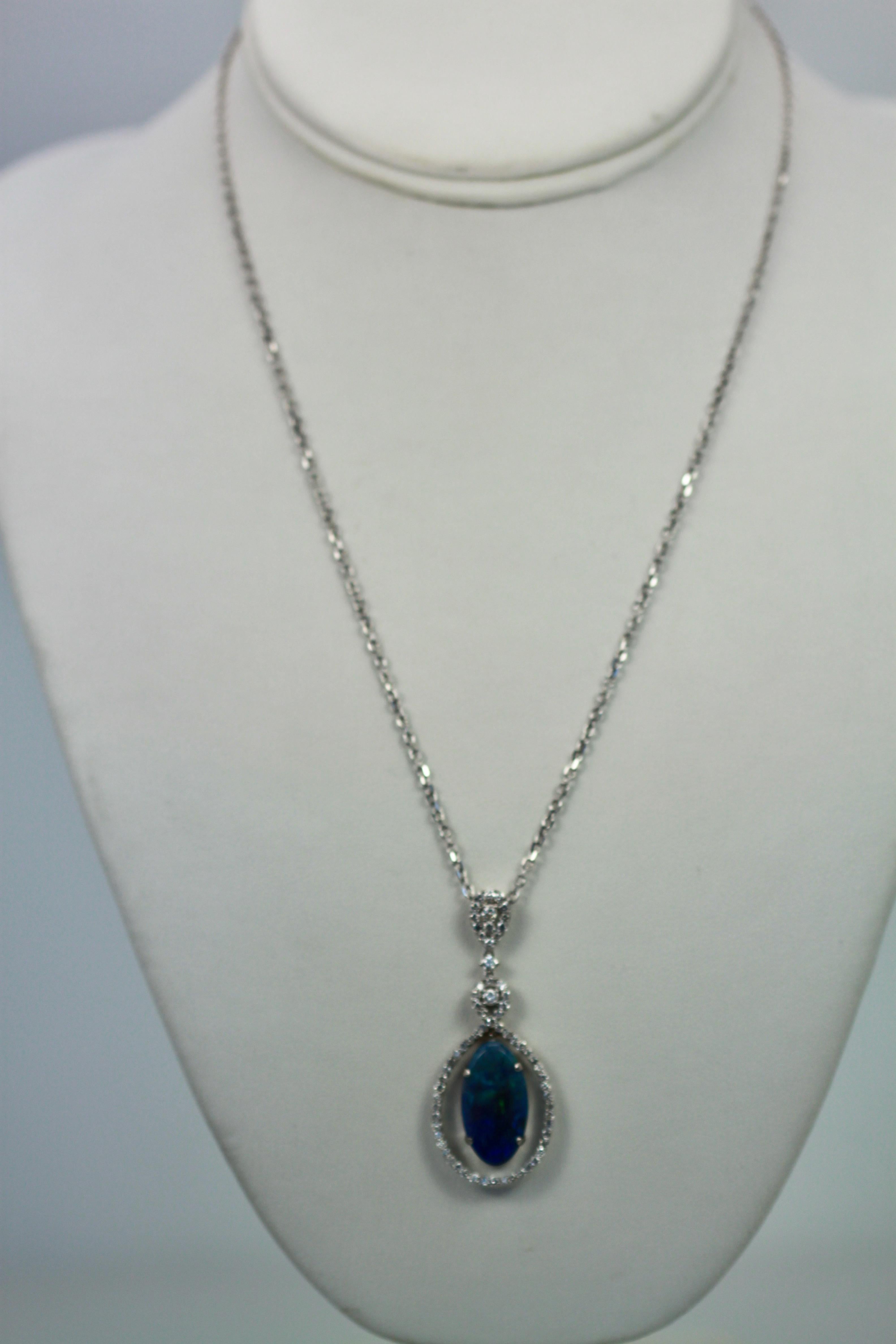 This Black Crystal Opal measures 20.4 x 11.0 x 3.4 and totals 5.23 Carats, the Diamond surround and loop weights in at 1.00 carat.  This pendant is 5cm long and 2cm wide.  Beautiful colors of blues purple and greens.  Comes with a 18
