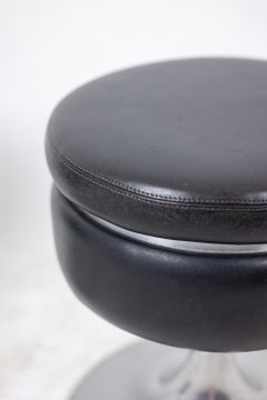Black cylindrical low stool, steel base. 1970s