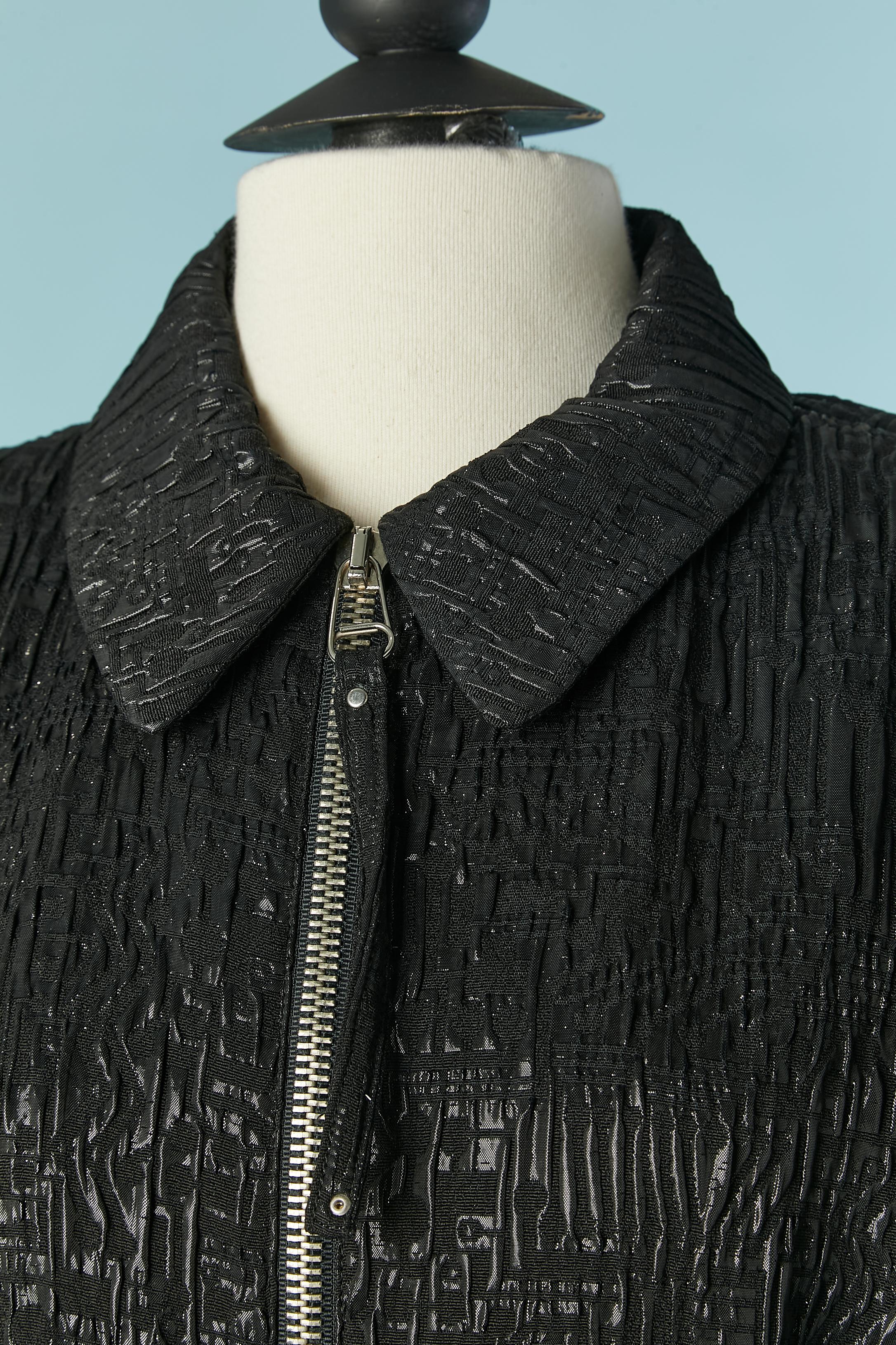 Black damask jacket with belt. Main fabric composition: 44% acetate, 36% rayon, 20% polyester. Printed striped rayon lining. 
Shoulder pad. Zip closure on the middle front. The belt is on black cotton with natural leather lining. Pocket on both side
