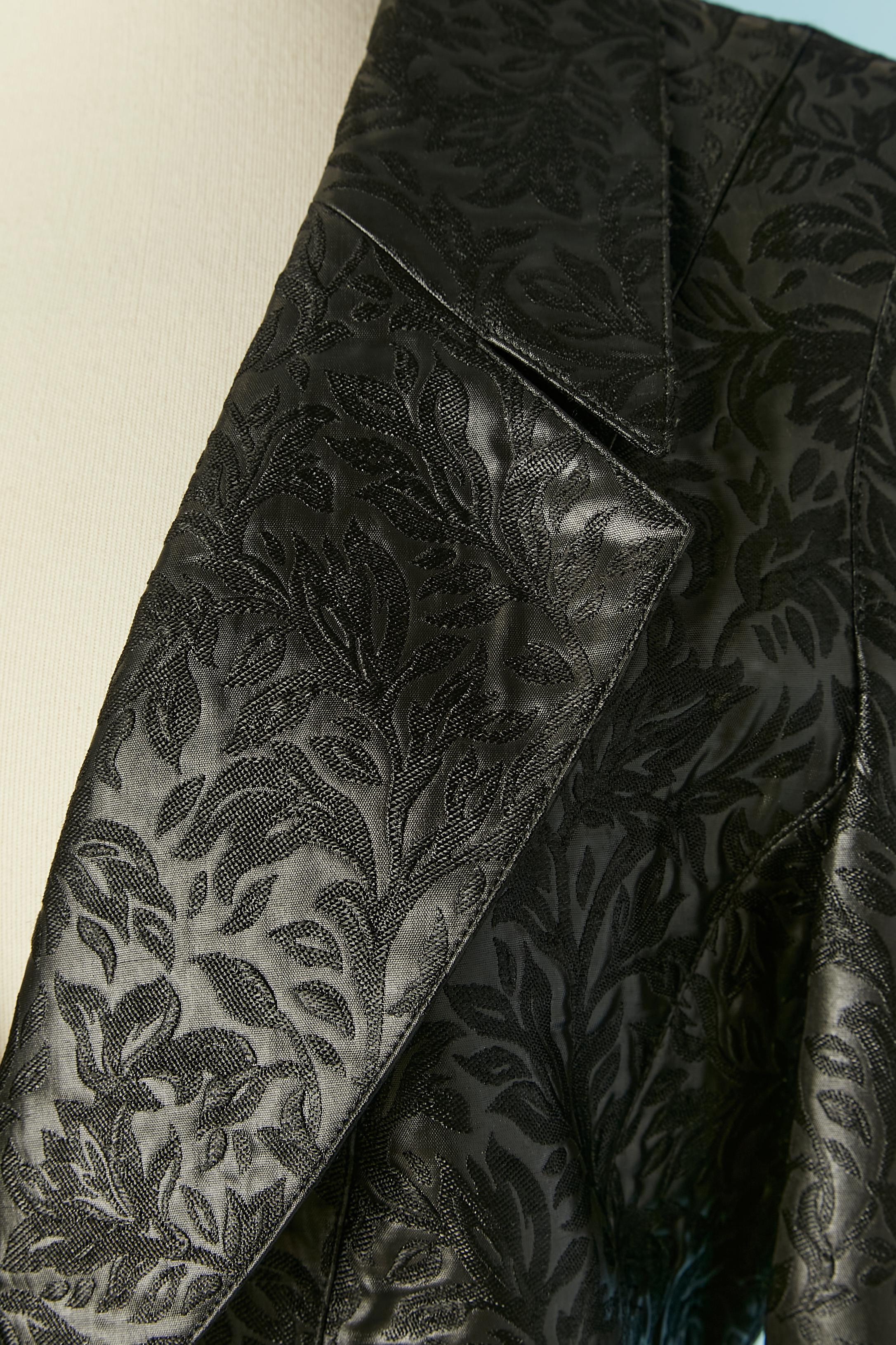 Black damask skirt-suit with pattern. Main fabric composition: 66% acetate, 34% polyester. Acetate lining. 
Button covered with the same fabric. Pockets on both side. 
SIZE 38 (Fr) 8 (Us) M for jacket 
SIZE 34/36 (Fr) 4/6 (Us) XS for the skirt (