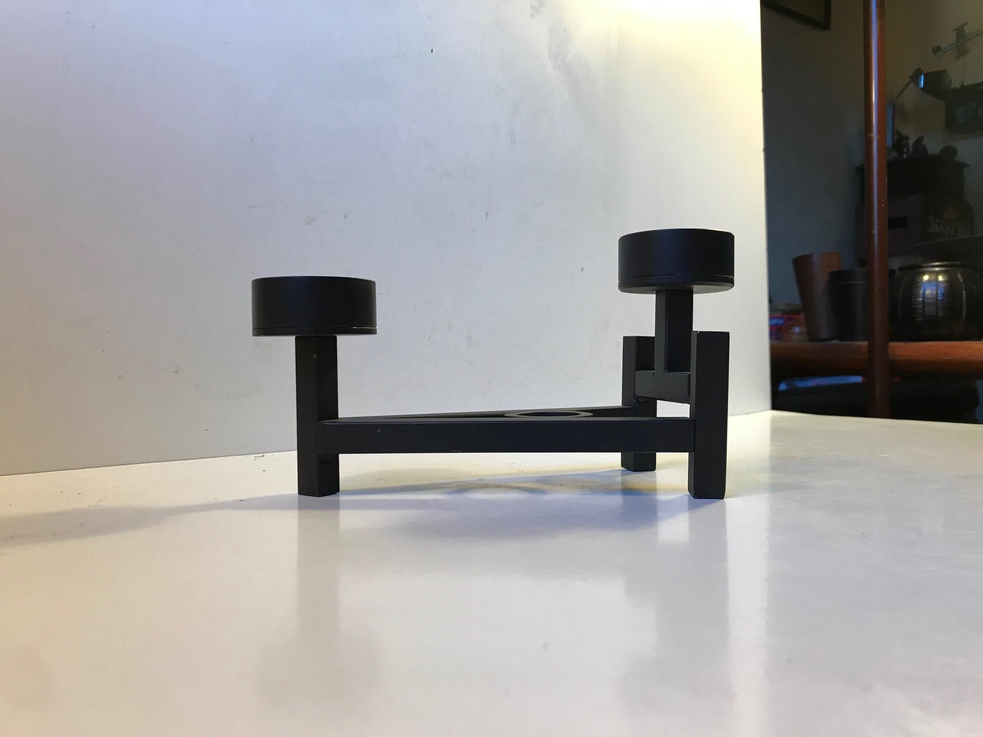 Brutalist Candleholder made by Danish design company Dantoft kunstartikler (trans.: art objects) during the early 1970s. It is made from black lacquered and welded iron and set in a footed triangular formation. It can be fitted with a Bloc/church or