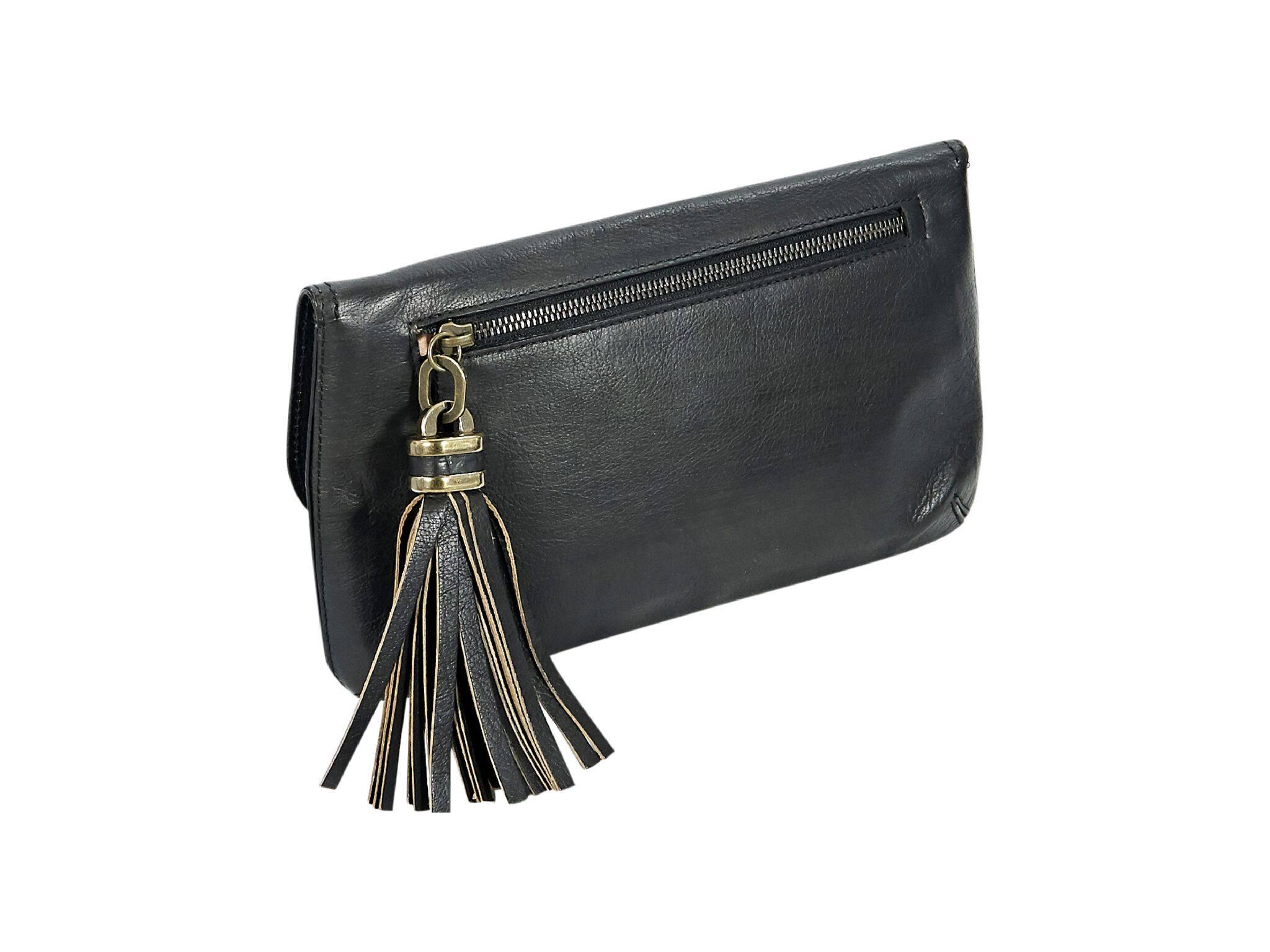 Product details:  Black leather Evie clutch by Derek Lam.  Front flap with concealed magnetic closure.  Lined interior with inner zip pocket.  Back exterior zip pocket with tassel pull.  Antiqued goldtone hardware.  Dust bag included.  12