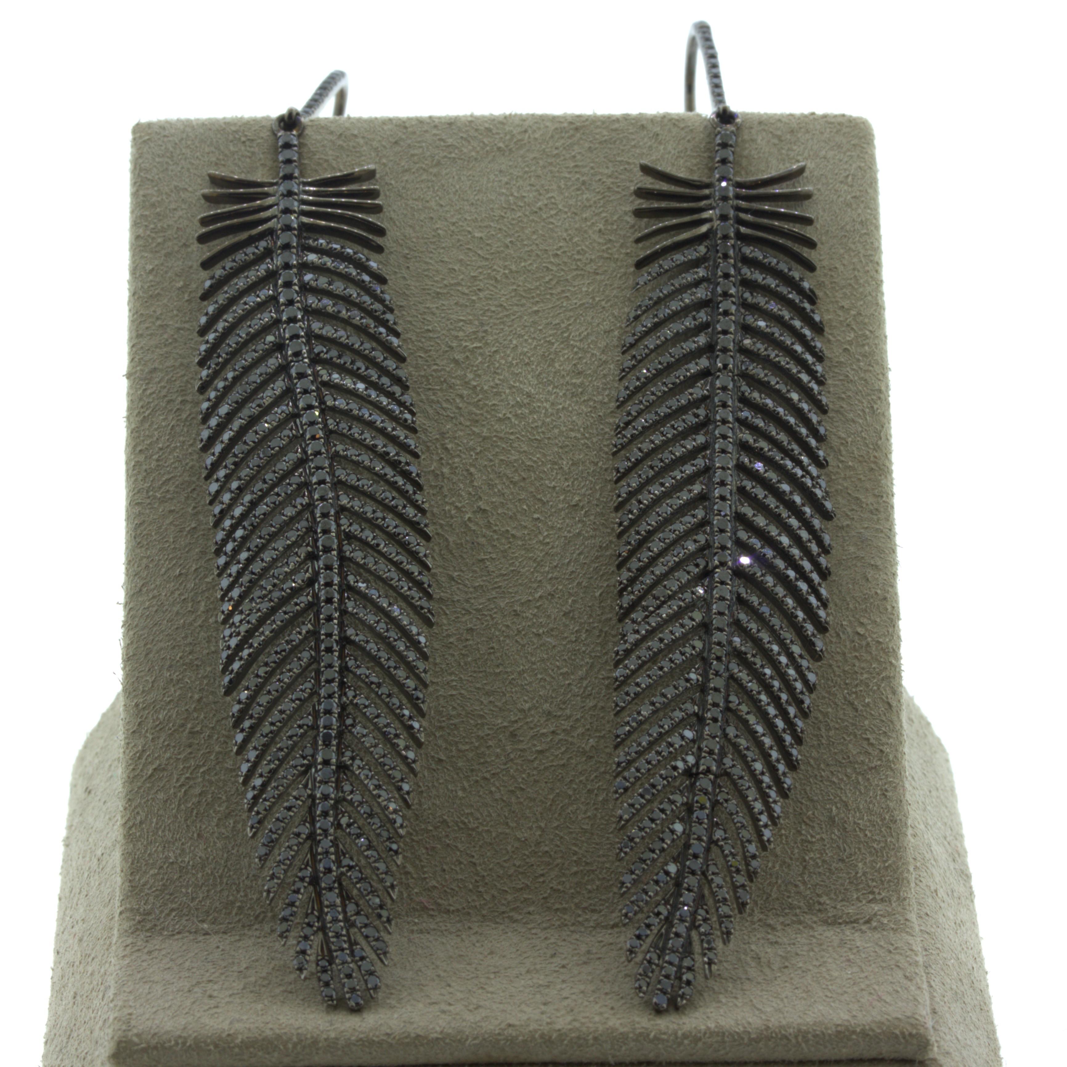 Black Diamond 18k Gold Feather Earrings

A long and delicate pair of feather earrings made in 18k gold with a rhodium plating giving the piece a black metallic look. They are set with 3.77 carats of round brilliant-cut black diamonds which sparkle