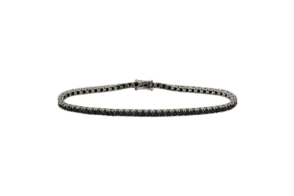 More Details:
Handmade in Italy
3,78ct Black Diamonds 
77 Black Diamonds
21cm in length
18kt White Gold

77 Black Diamonds make up this ultra cool tennis bracelet which has been handset in our 150 year old workshop. The clasp is made up of two